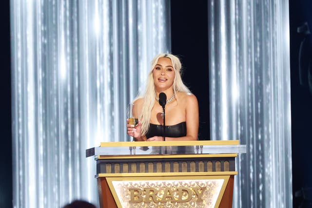 <p>Kim Kardashian speaks onstage during Tom Brady’s roast</p>