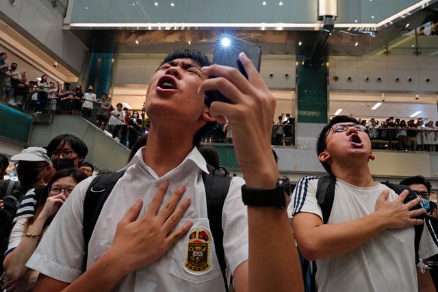 <p>People sing ‘Glory to Hong Kong’ in a shopping mall in Hong Kong on 11 September 2019</p>
