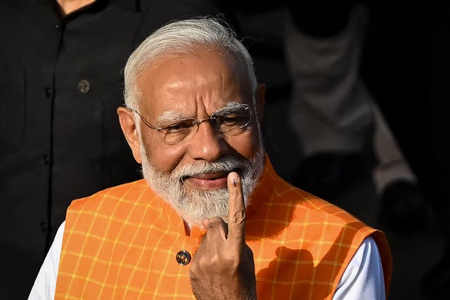 <p>India’s prime minister Narendra Modi, leader of the ruling Bharatiya Janata Party (BJP) displays his inked marked finger after casting his ballot at a polling booth at Ranip, Ahmedabad on 7 May 2024</p>
