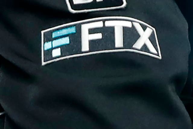 <p>The FTX logo appears on home plate umpire Jansen Visconti's jacket at a baseball game with the Minnesota Twins on 27 September, 2022</p>