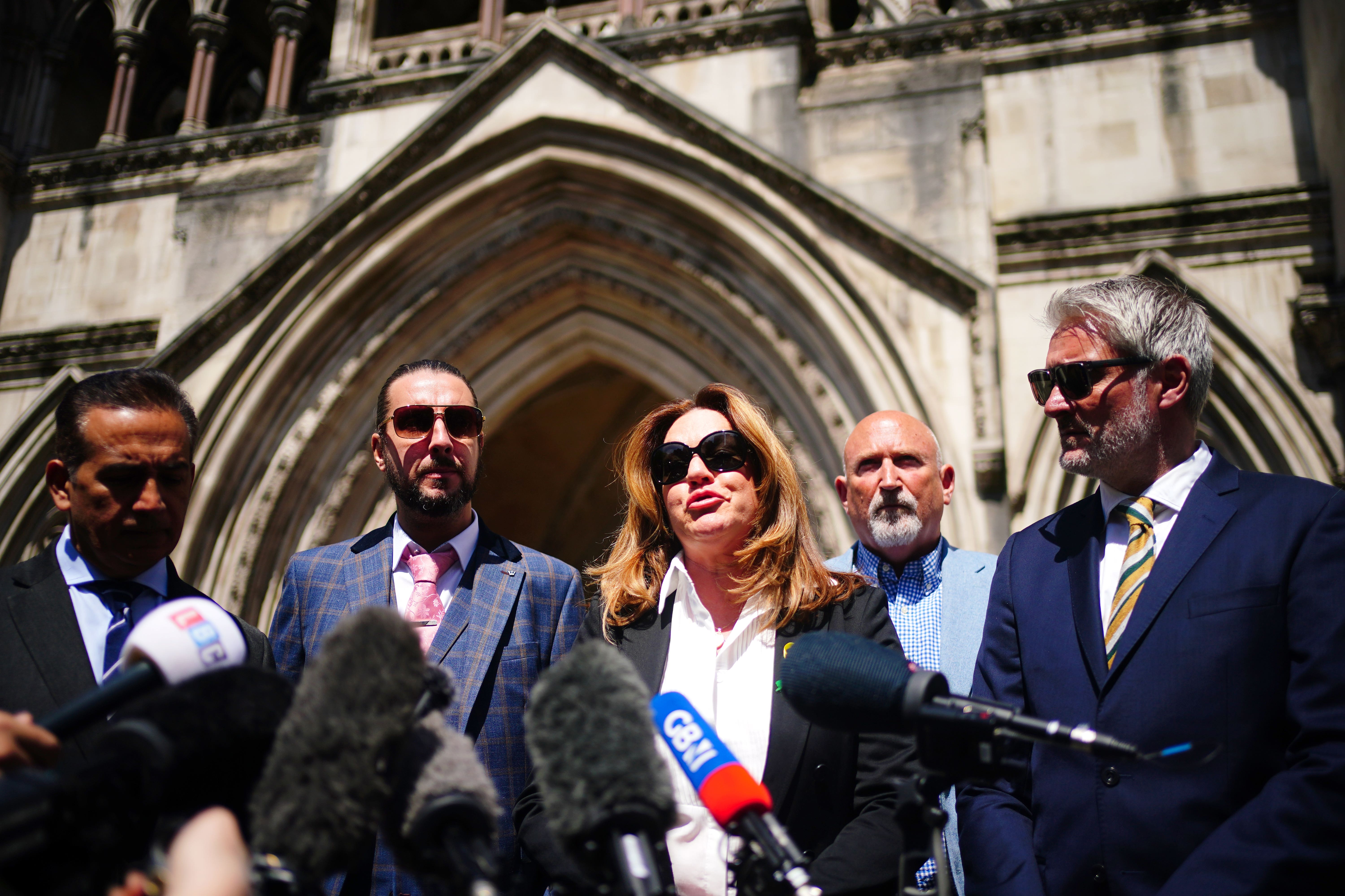 The families of the victims outside the Royal Courts of Justice in London (Victoria Jones/PA)