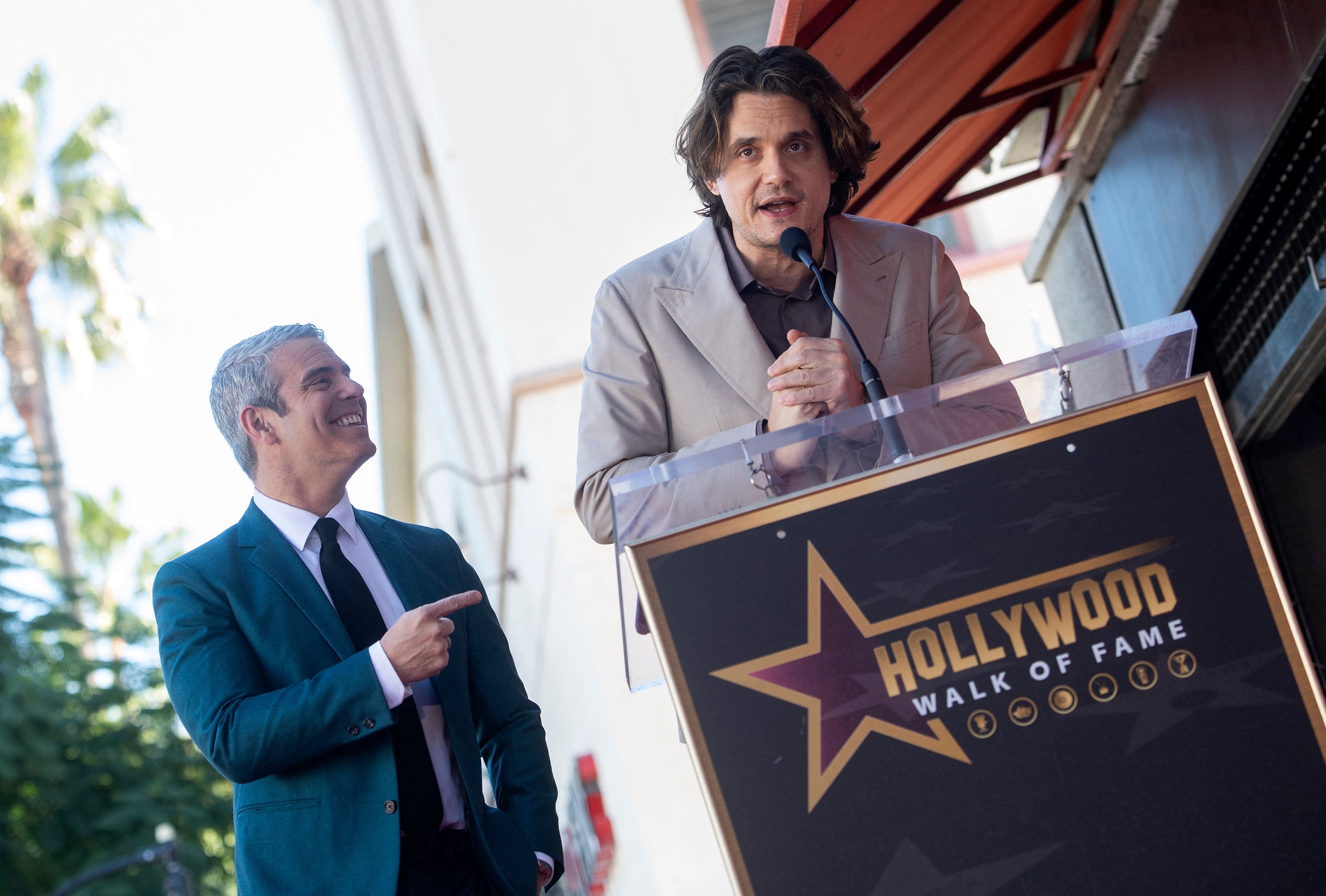 US singer-songwriter John Mayer (R) speaks onstage during the ceremony to honor Talk Show host Andy Cohen (L) with a Hollywood Walk of Fame star in Los Angeles, California, on 4 February 2022