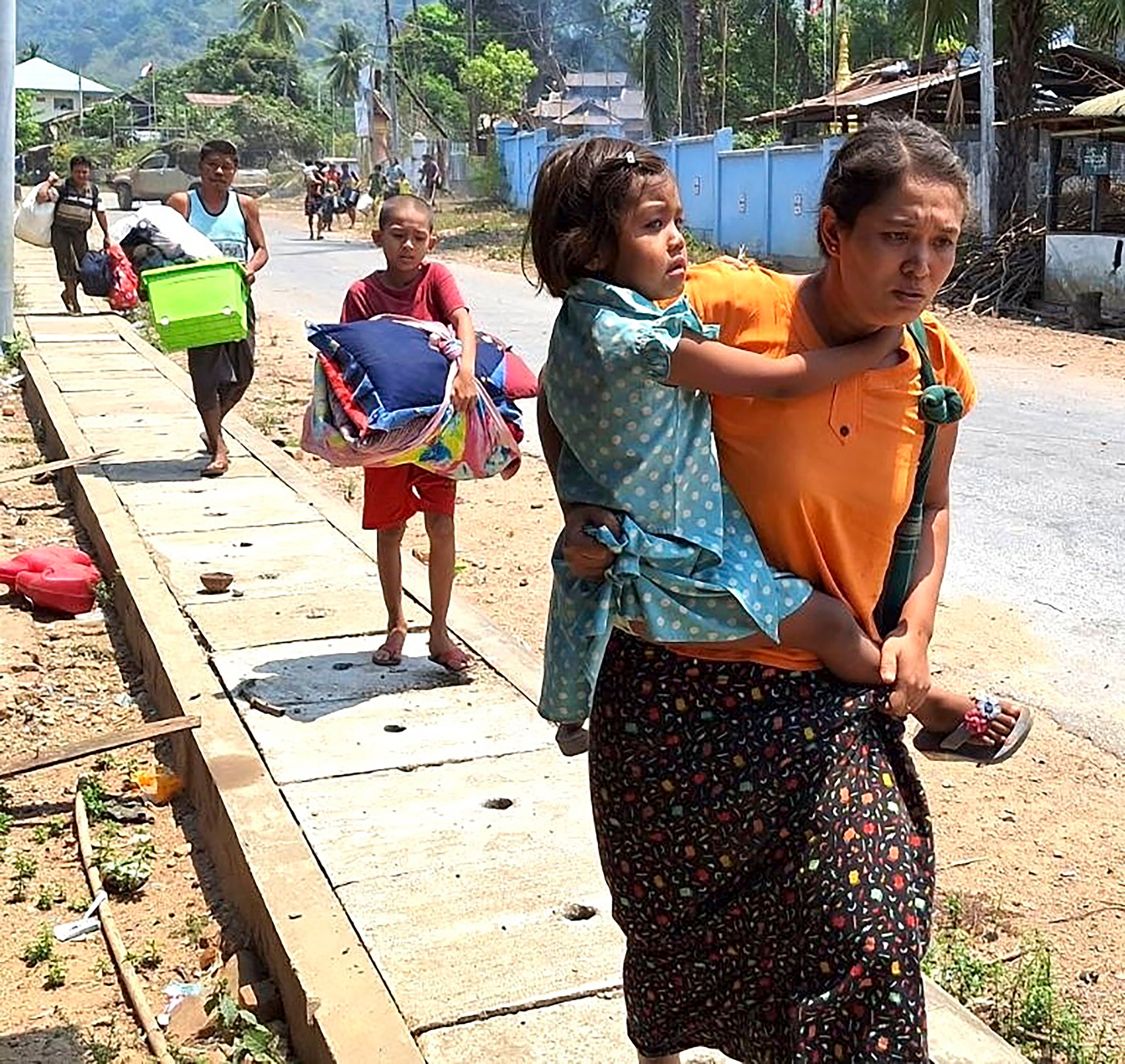 File. People flee after a Buddhist monastery sheltering civilians displaced by fighting is attacked by a junta warplane in the town of Papun on 31 March 2024