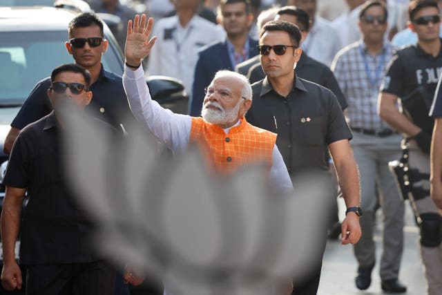 <p>Narendra Modi waves as he votes in the third phase of India’s election in Ahmedabad, Gujarat </p>