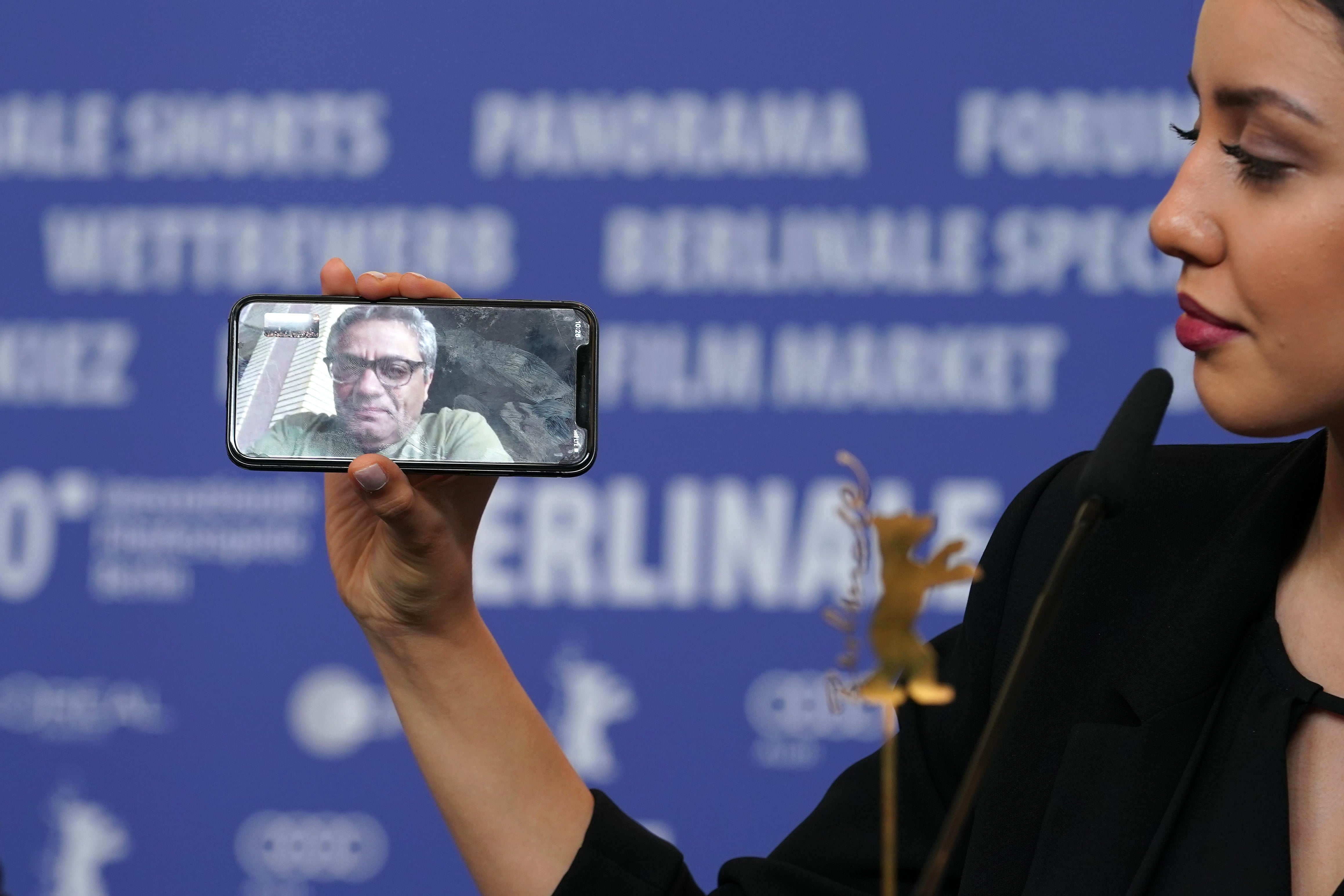 Baran Rasoulof phones Iranian director Mohammad Rasoulof, winner of the Golden Bear for Best Film for the film “There Is No Evil” at the award winners press conference during the 70th Berlinale International Film Festival Berlin