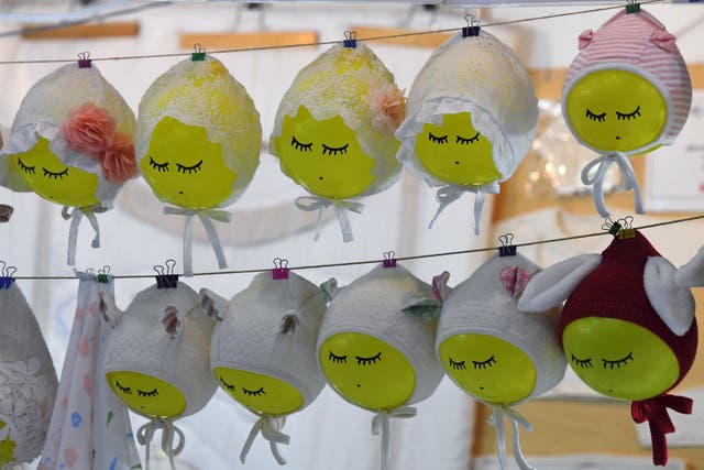 <p>File: Baby bonnets displayed on a booth at a baby fair in Seoul</p>