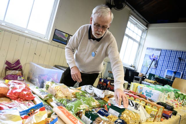 <p>A volunteer at Bonny Downs Community Association food club during a visit as part of Sainsbury's and Comic Relief's campaign to raise awareness of food poverty in the UK</p>