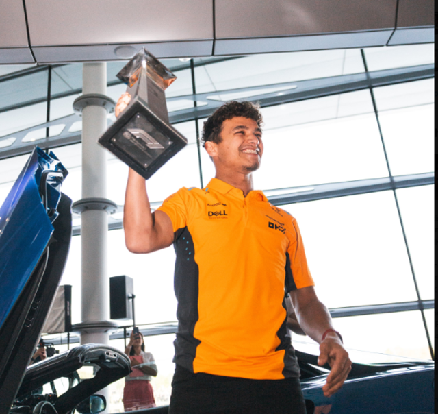 <p>Lando Norris arrives back at McLaren HQ with his first-place trophy after his win in Miami </p>