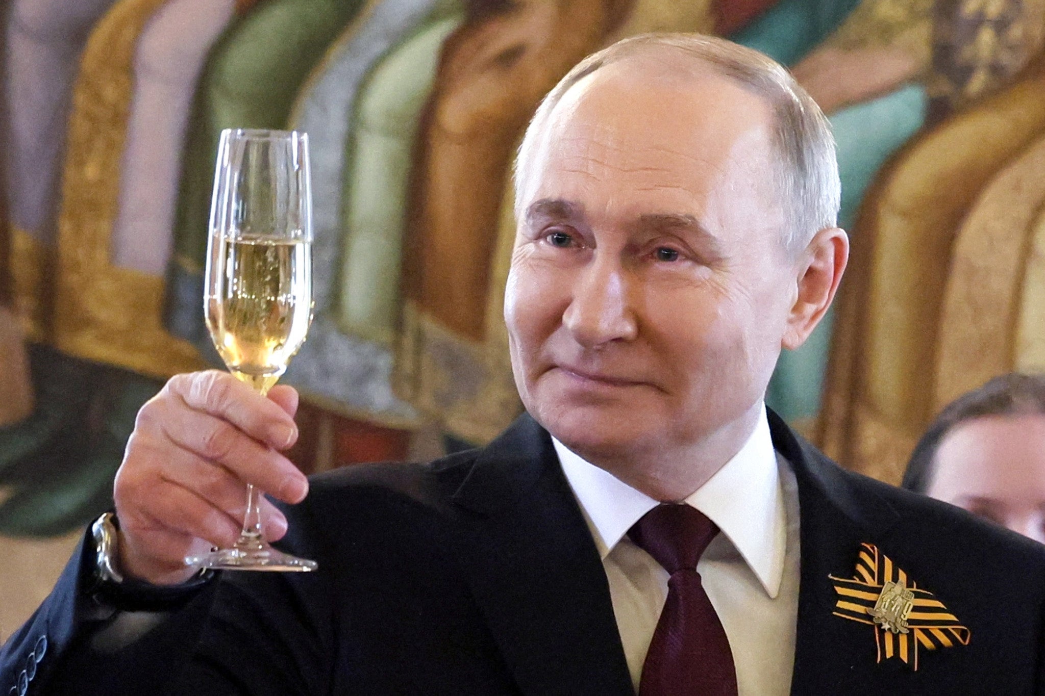 Putin raises a toast during a ceremony following the parade