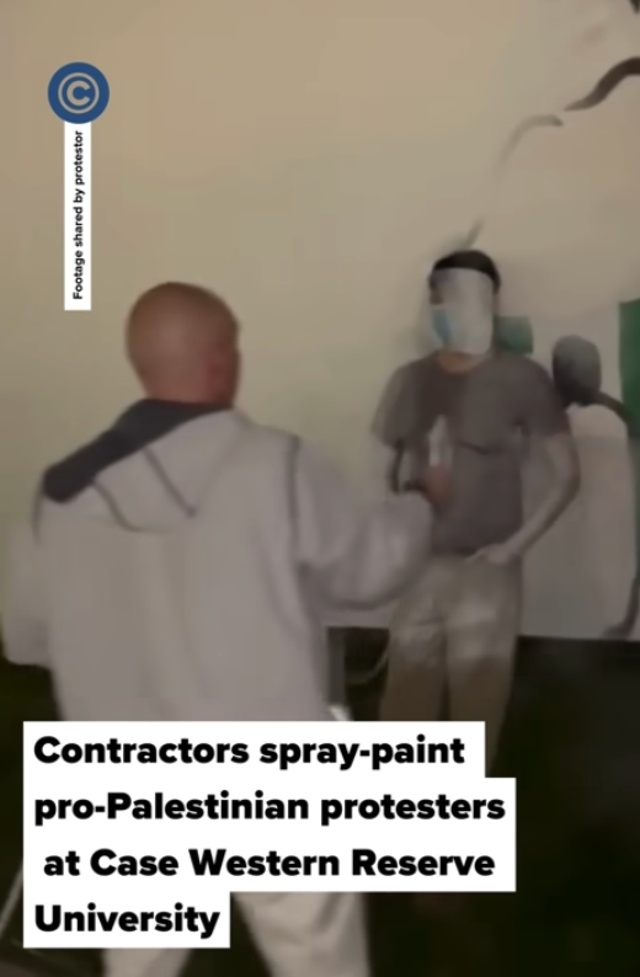 <p>A contractor hired by Case Western Reserve University paints over a pro-Palestinian protester on 7 May. The next day, antiwar protesters occupied an administrative building on campus</p>