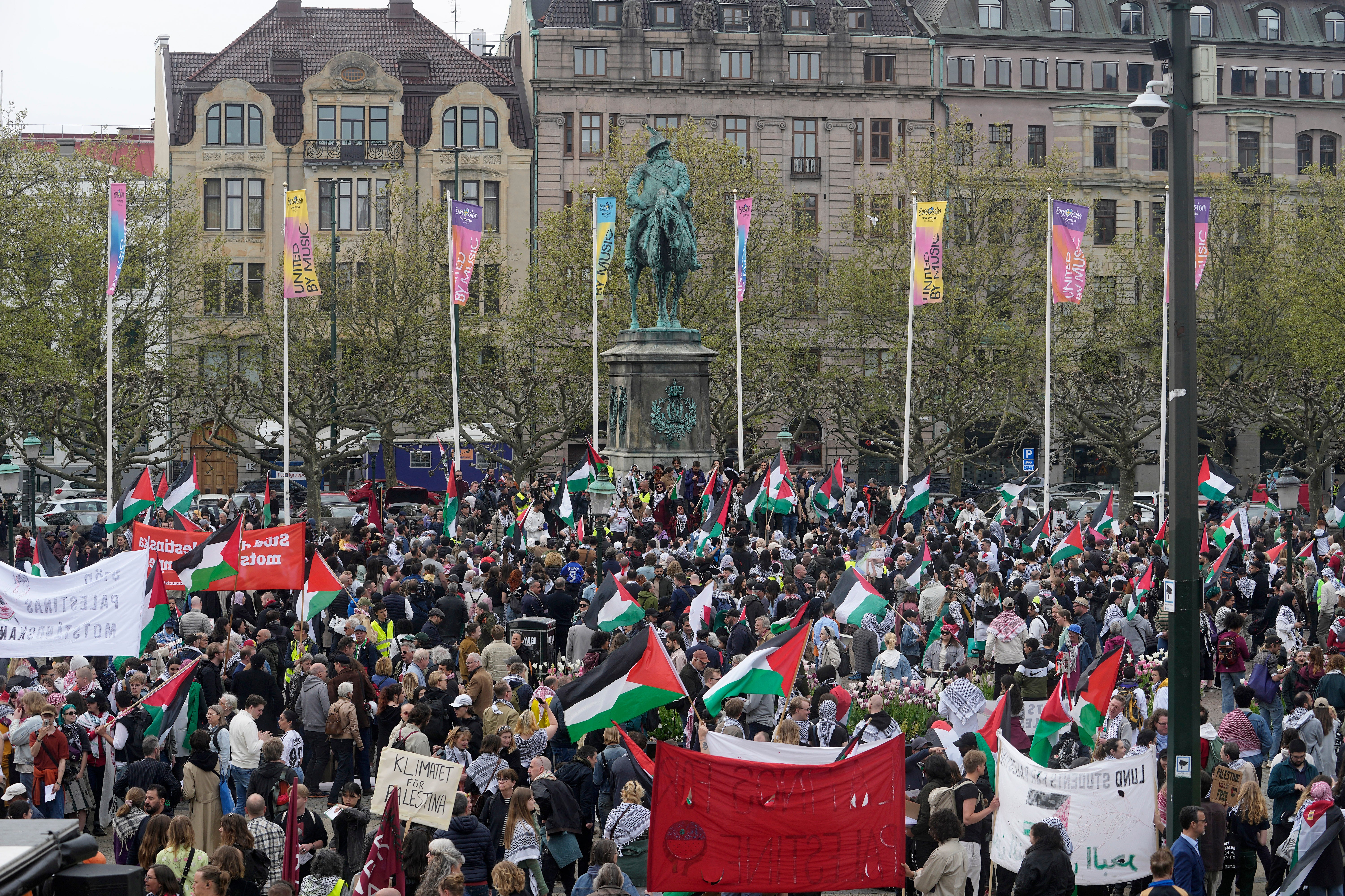 Protesters gather in Sweden near the Malmö Arena as they wave Palestinian flags