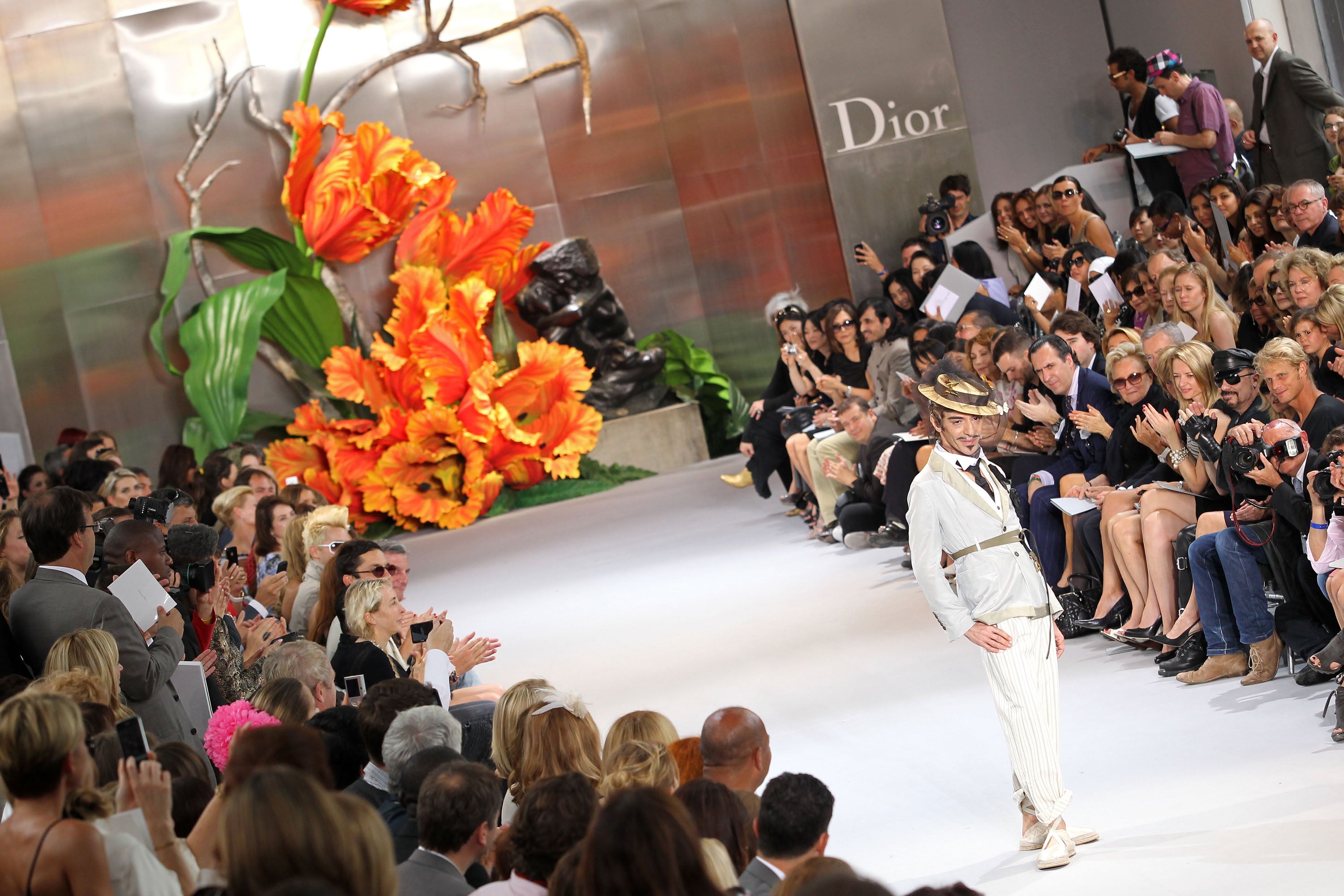 John Galliano walks the runway at the end of the Dior show as part of the Paris Haute Couture Fashion Week Fall/Winter 2011 event at Musee Rodin on 5 July 2010