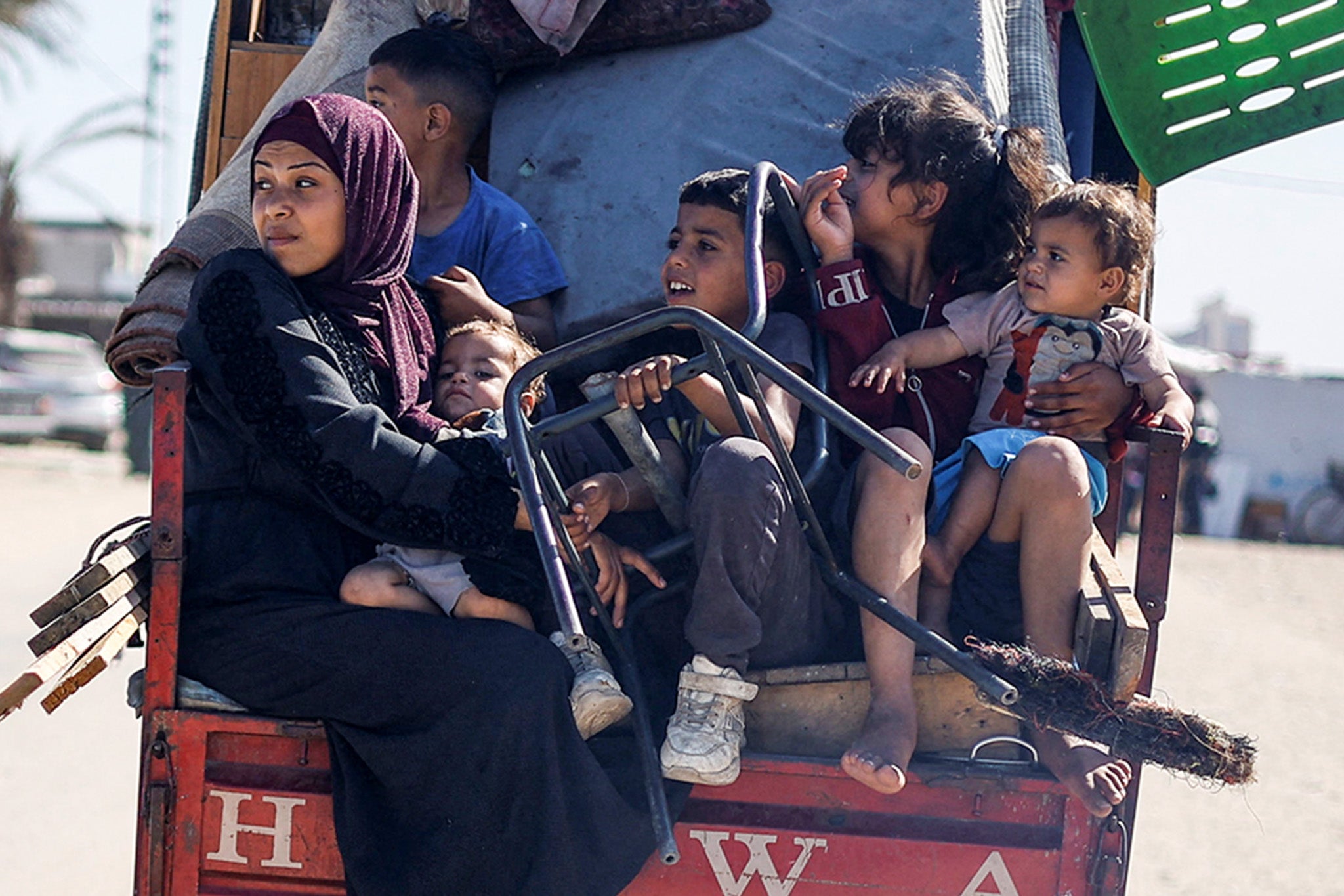 Palestinians travel in a vehicle as they flee Rafah