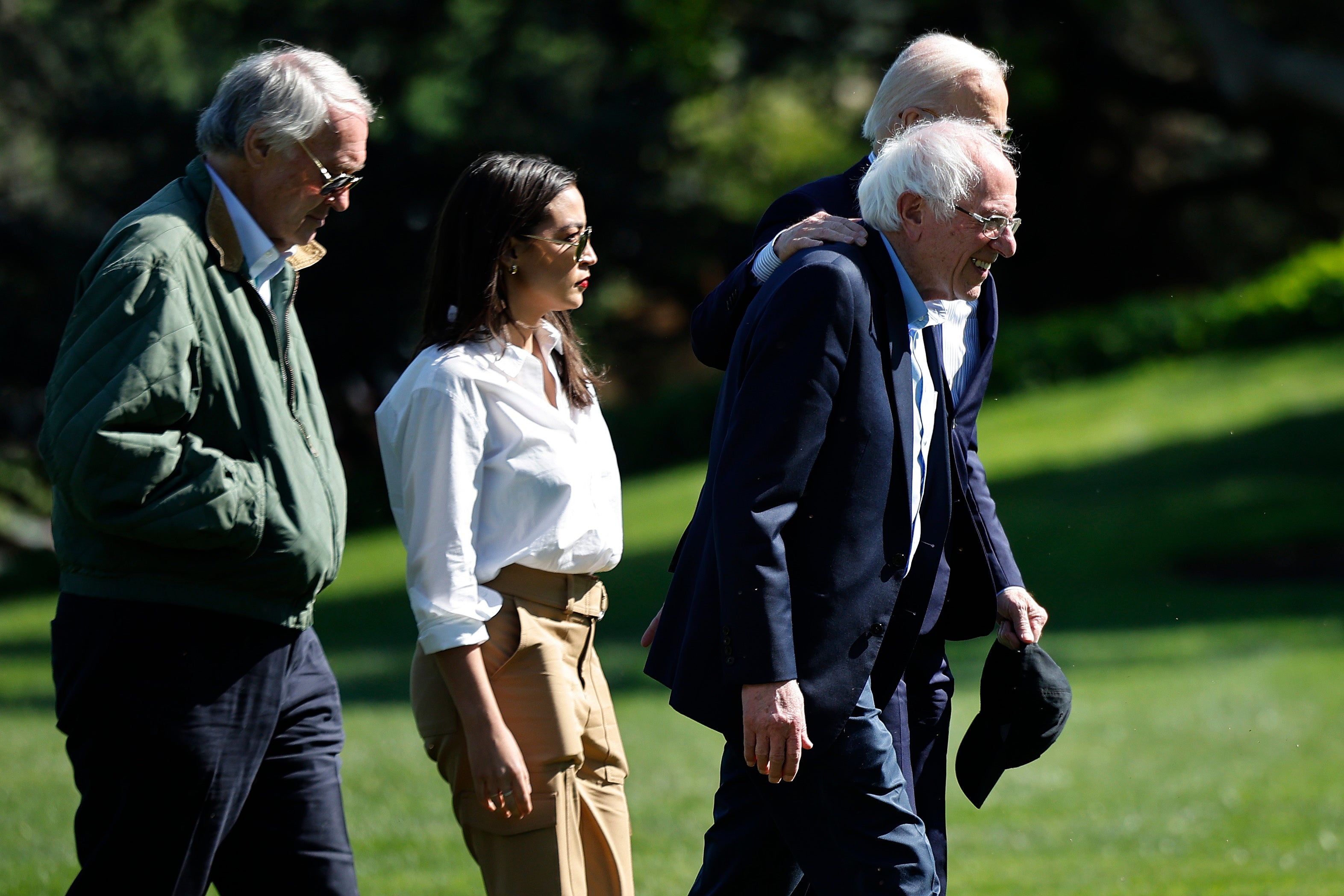 WASHINGTON, DC - APRIL 22: U.S. President Joe Biden (R), Sen. Bernie Sanders (I-VT), Sen. Ed Markey (D-MA) (L) and Rep. Alexandria Ocasio Cortez (D-NY) walk to the Oval Office after returning to the White House on April 22, 2024 in Washington, DC. Biden and the members of Congress returned to the White House following an Earth Day event in Virginia. (Photo by Chip Somodevilla/Getty Images)