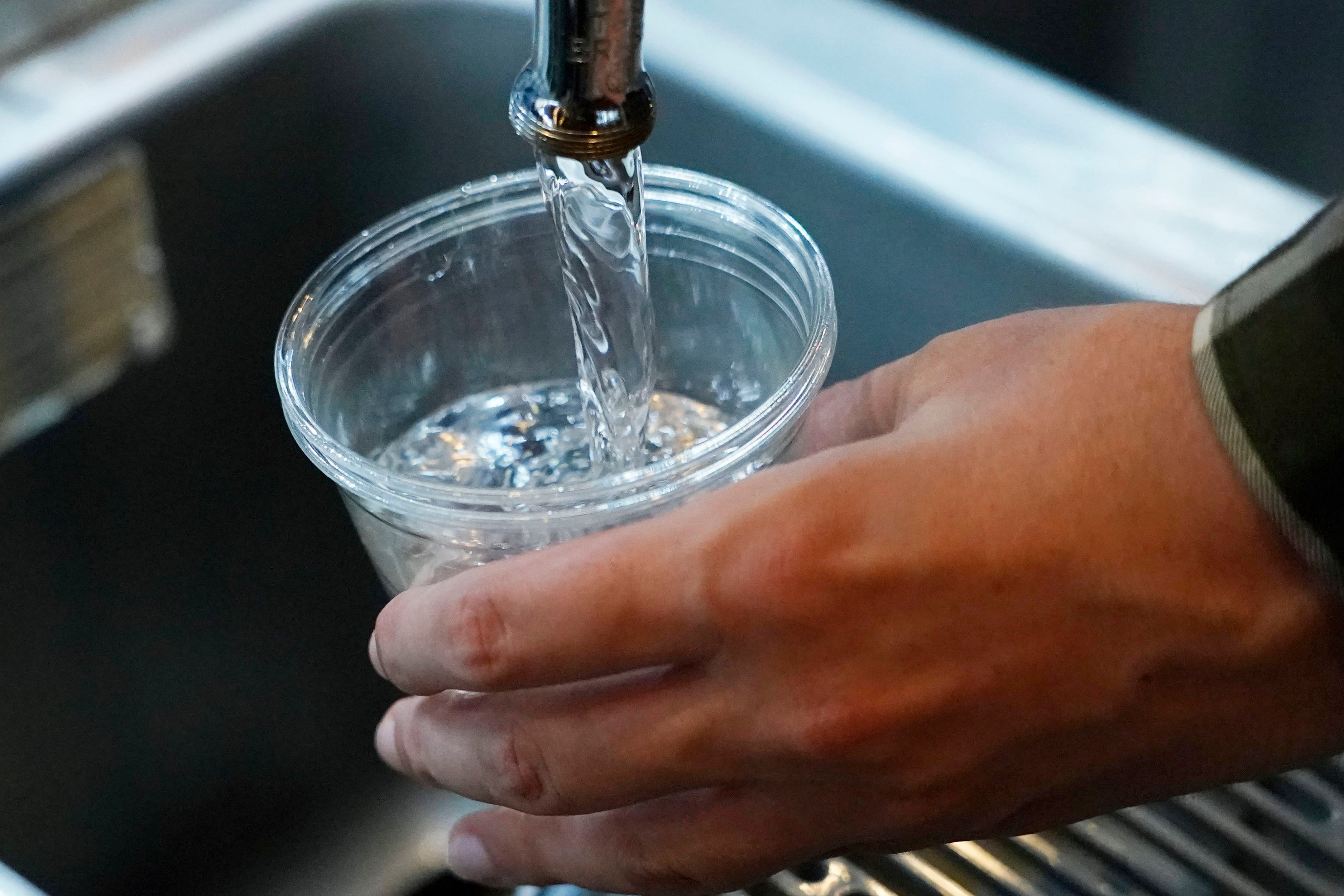 A cup of water is drawn from a faucet at Johnny T's Bistro and Blues in Jackson, Missippi, in September 2022. The southern state requires that all community water systems serving at least two-thousand people implement fluoridation, according to the Fluoride Action Network