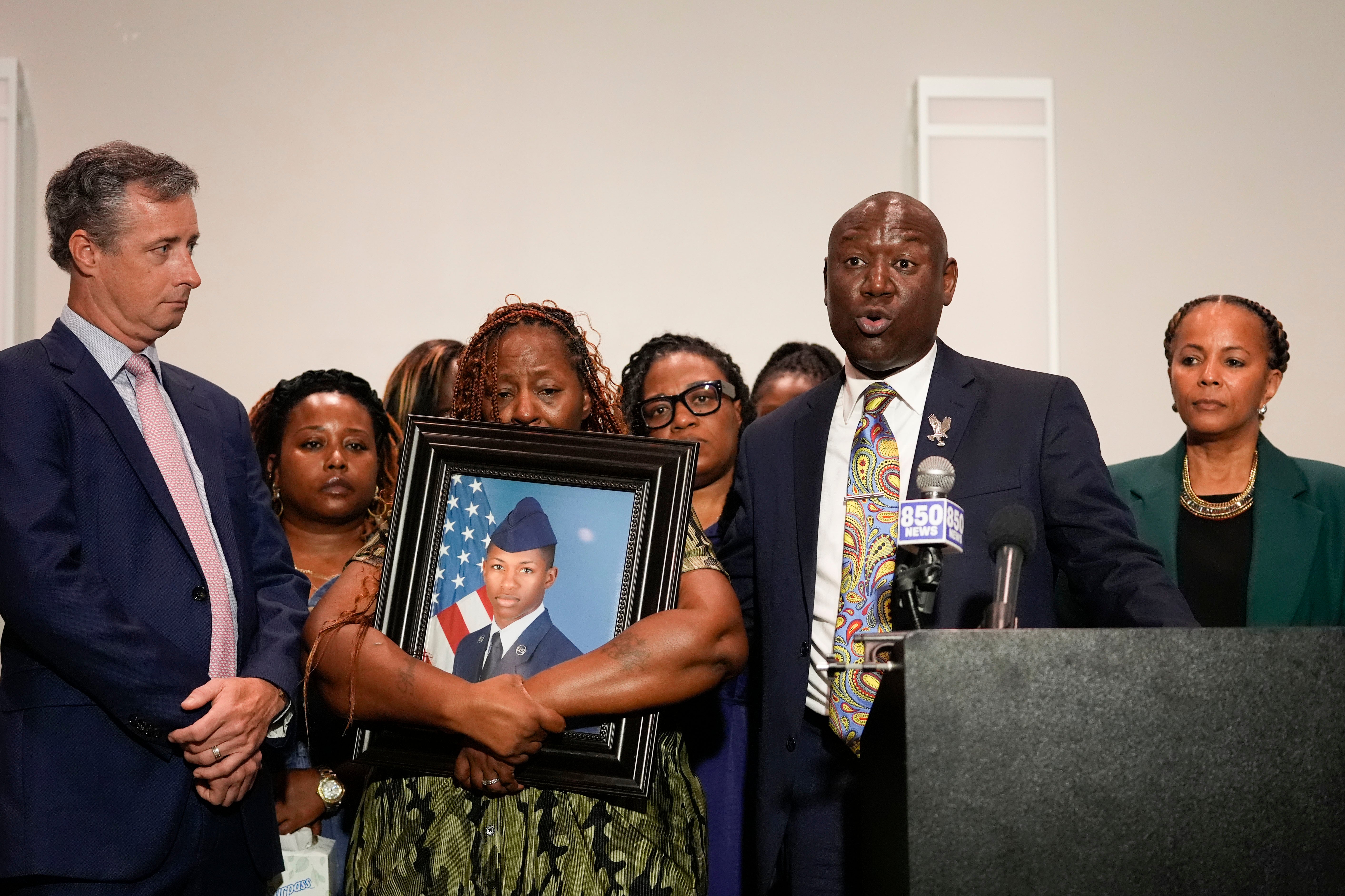 Chantimekki Fortson, mother of Roger Fortson, a US Air Force airman, holds a photo of her son during a news conference regarding his death, along with family and Ben Crump