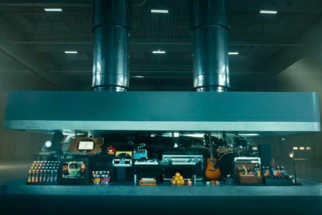 <p>In this image taken from a video advertisement, a hydraulic press crushes an array of creative instruments</p>
