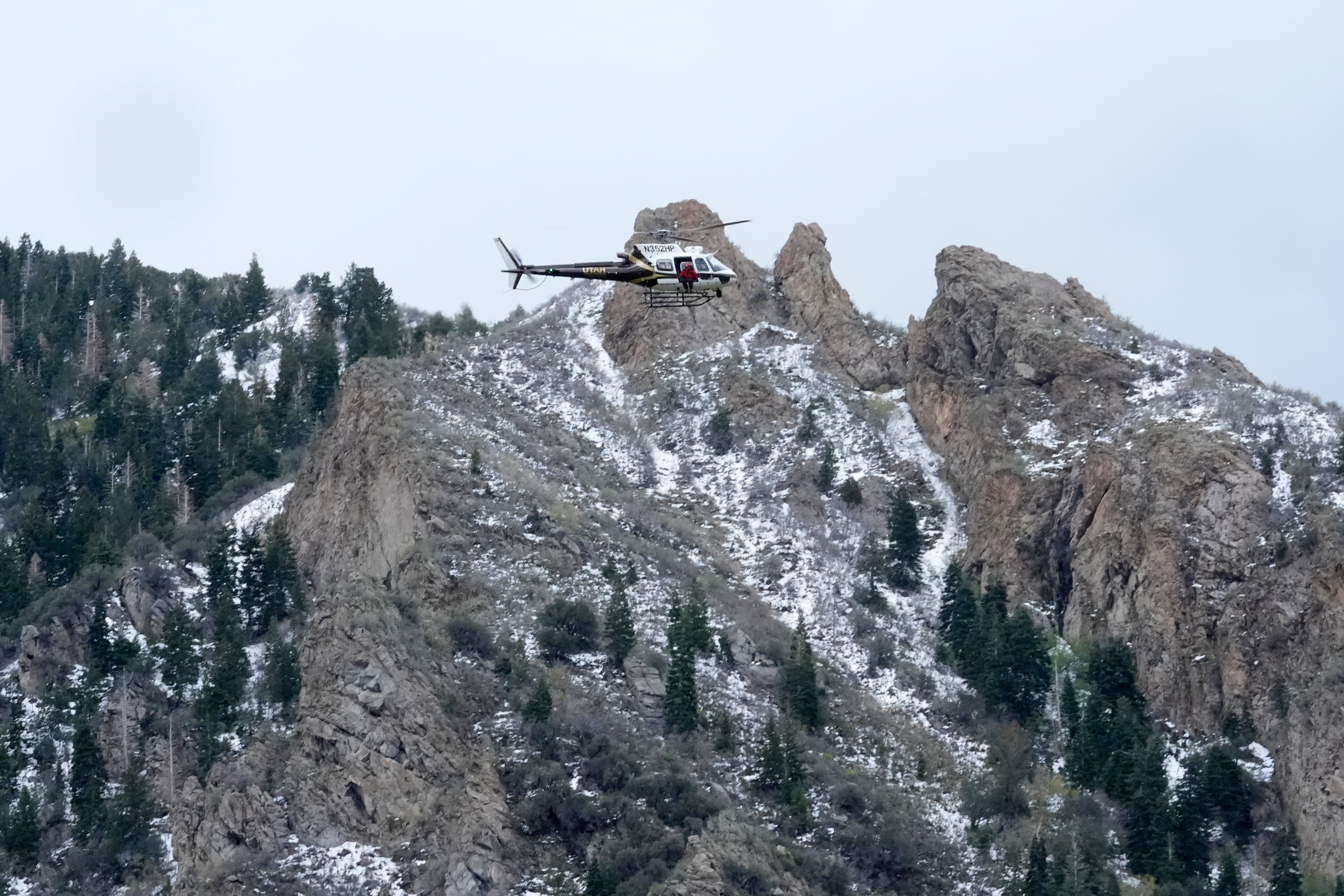 A Utah Department of Public Safety helicopter carries rescuers from Hidden Valley Park on 9 May 2024 in Sandy, Utah