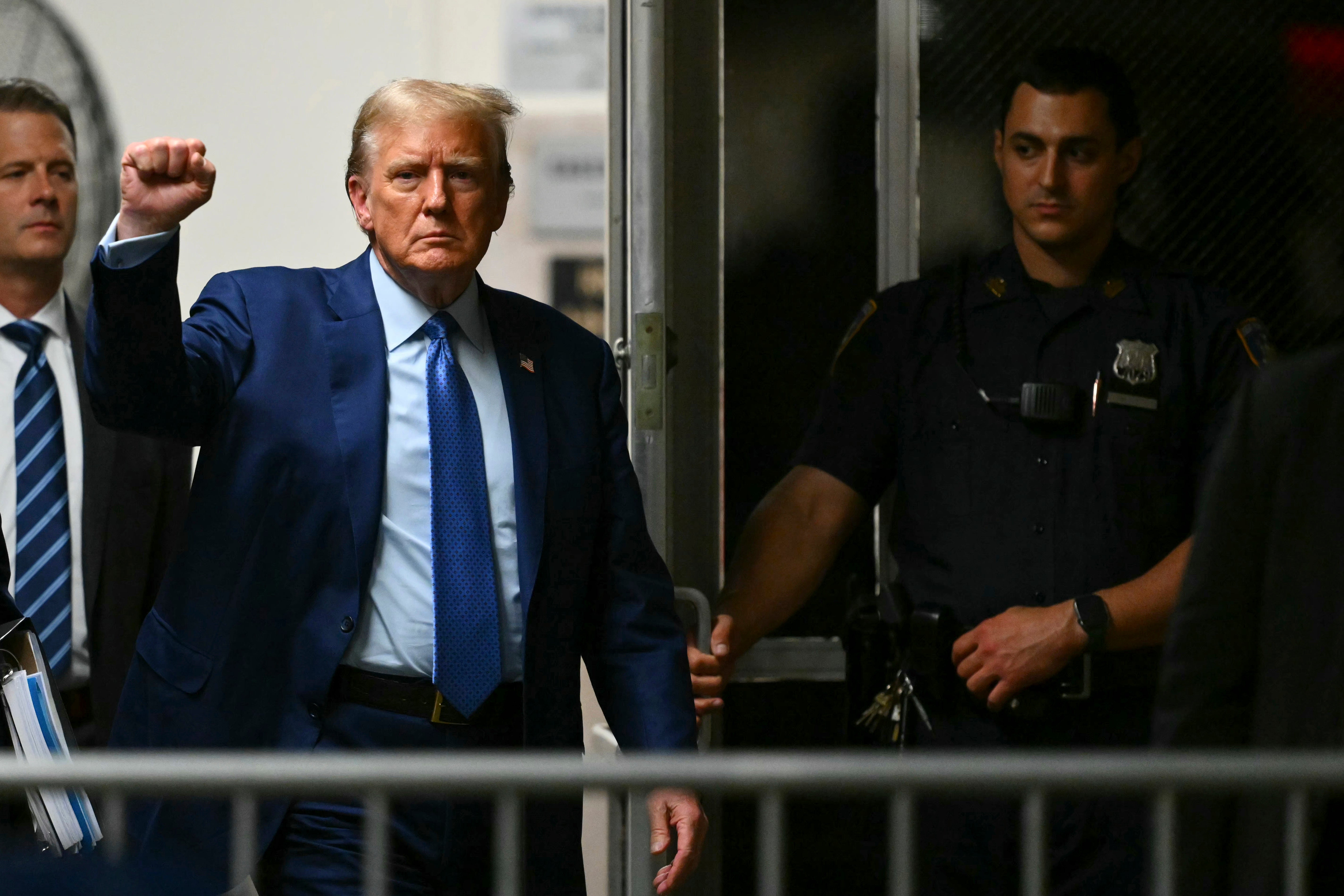 Former President Donald Trump gestures as he walks to the courtroom following a break in his trial at Manhattan criminal court on Thursday
