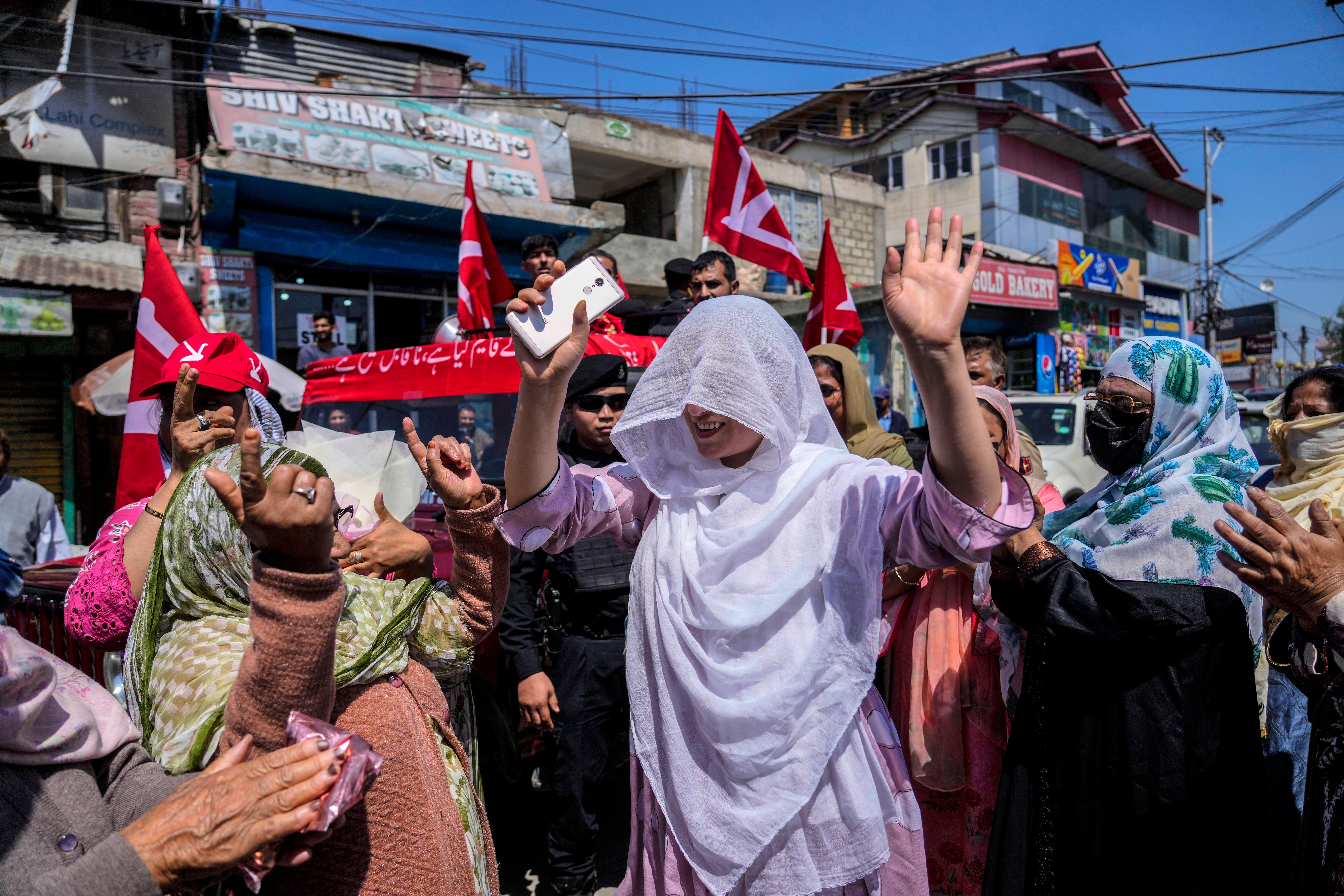 Supporters of National Conference party dance during an election rally in Srinagar, Kashmir