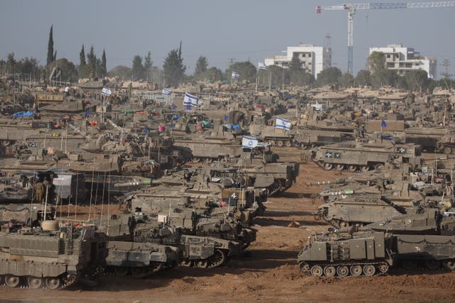 <p>Israeli military vehicles gather near the border fence with the Gaza Strip, at an undisclosed location in southern Israel, ahead of an expected offensive in Rafah </p>
