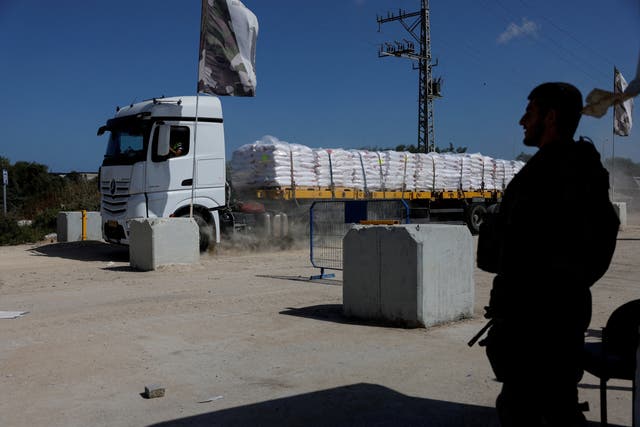 <p>An Israeli soldier stands guard as a truck carrying humanitarian aid is seen near the Erez crossing in southern Israel </p>