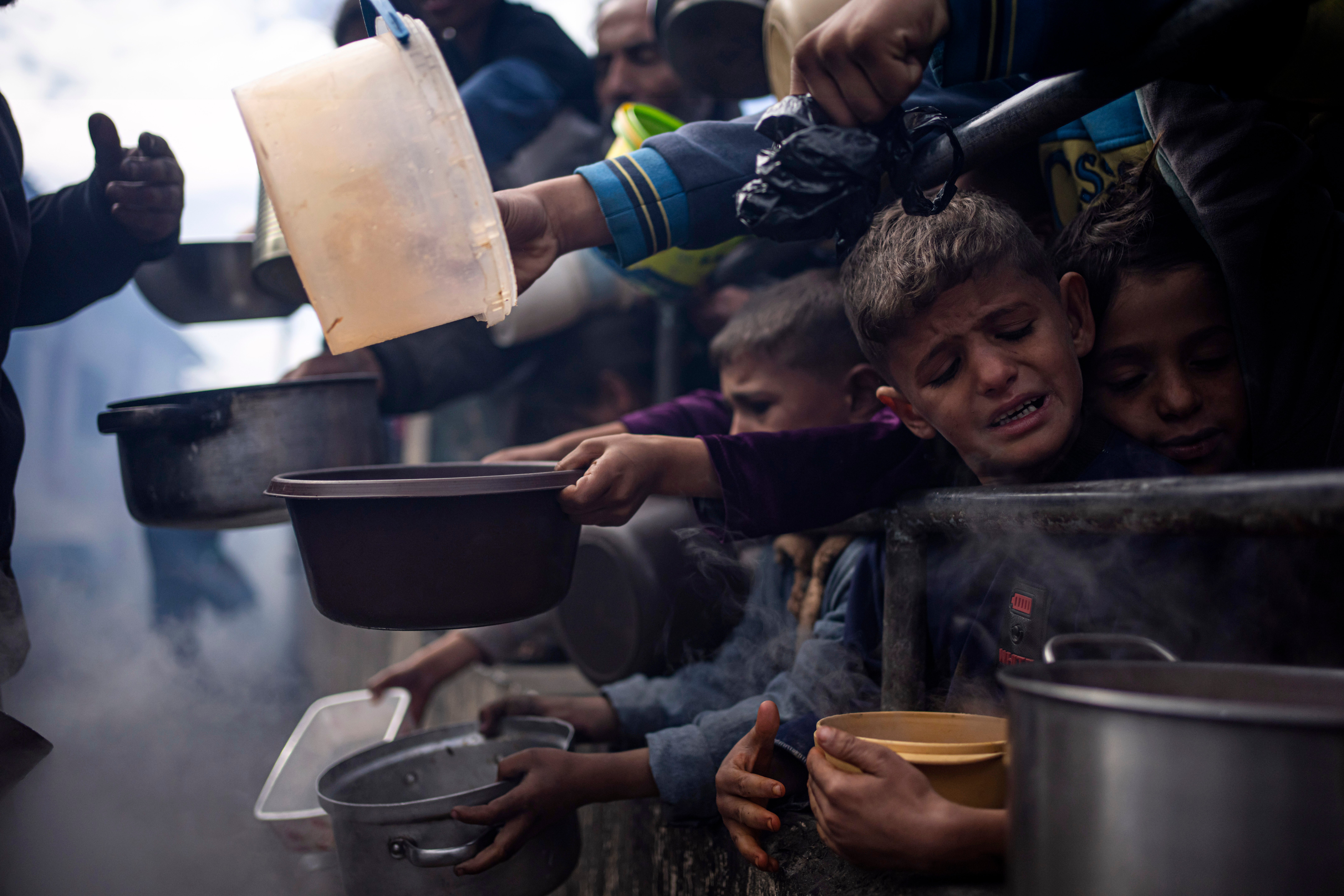 Palestinians line up for a meal in Rafah, Gaza Strip, in February. The region is facing acute hunger and is on the brink of famine as the Israeli siege continues