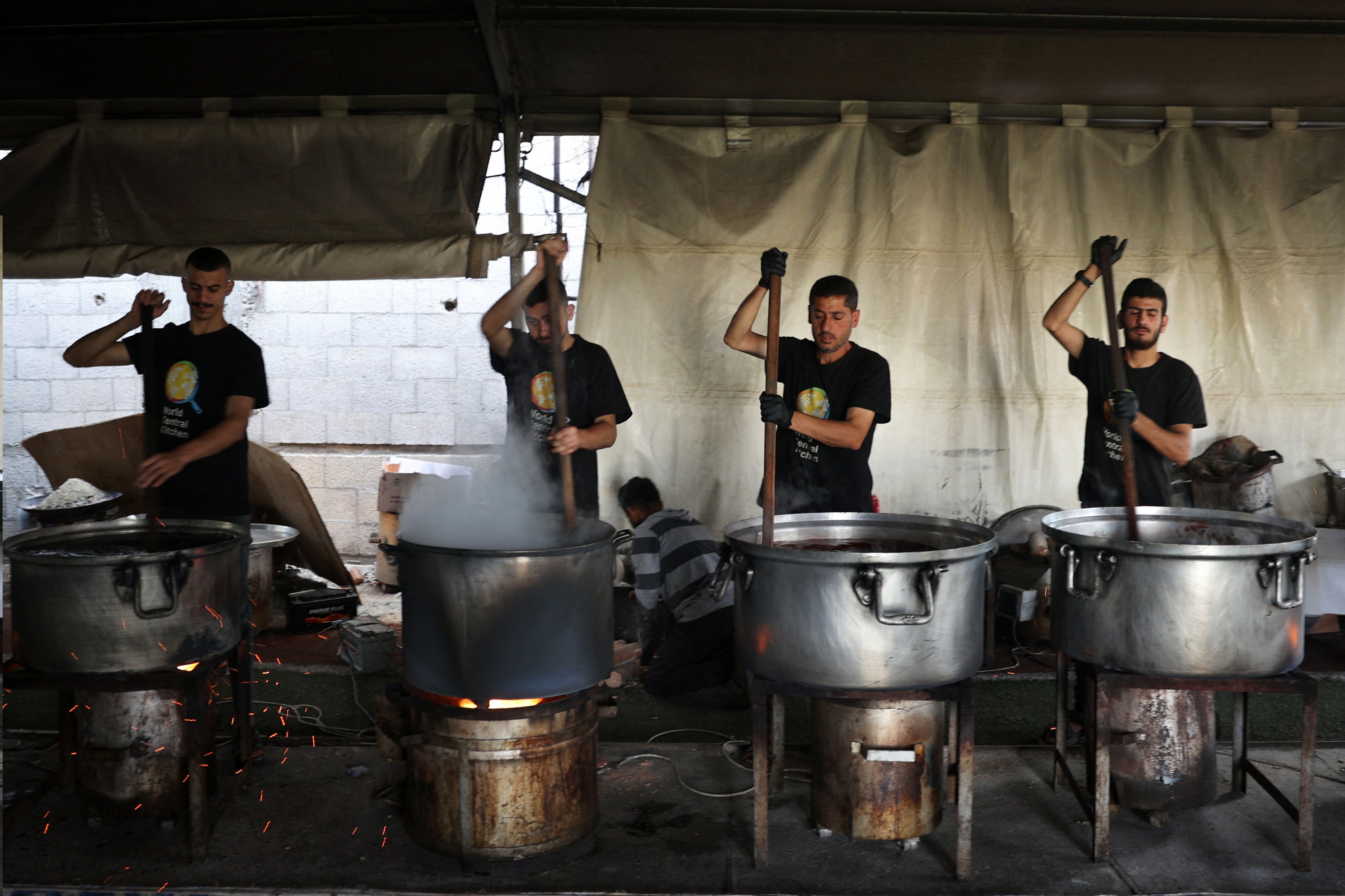 Volunteers from the World Central Kitchen cook meals to be distributed to needy Palestinians in Rafah