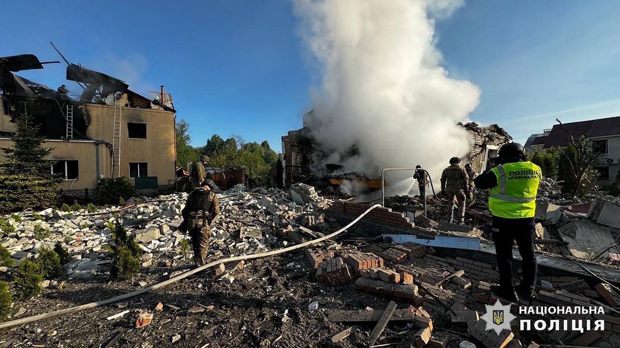 Employees of the State Emergency Service extinguishing fires of private houses destroyed by a shelling in Kharkiv, northeastern Ukraine