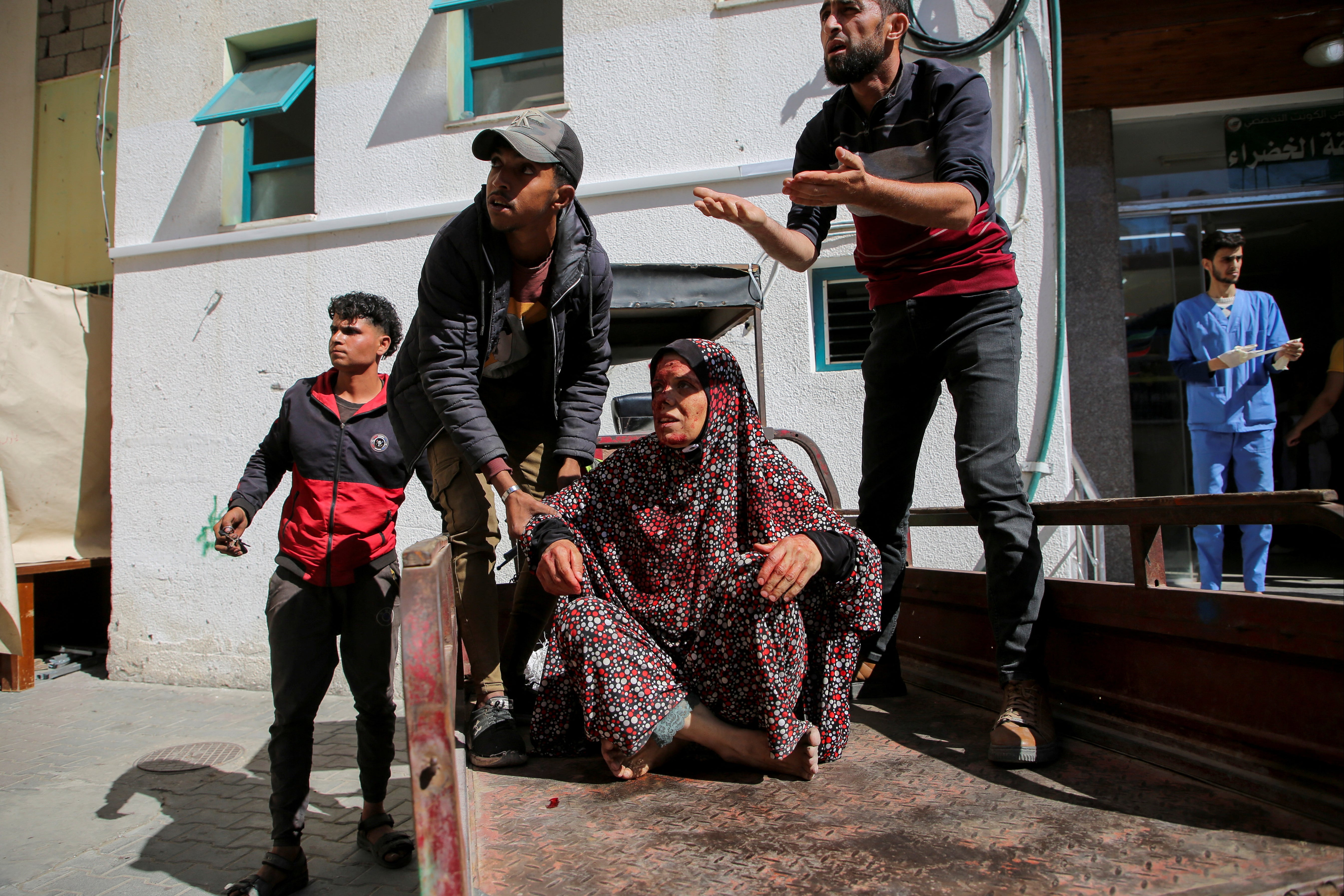 A Palestinian woman wounded in an Israeli strike is rushed into a hospital in Rafah