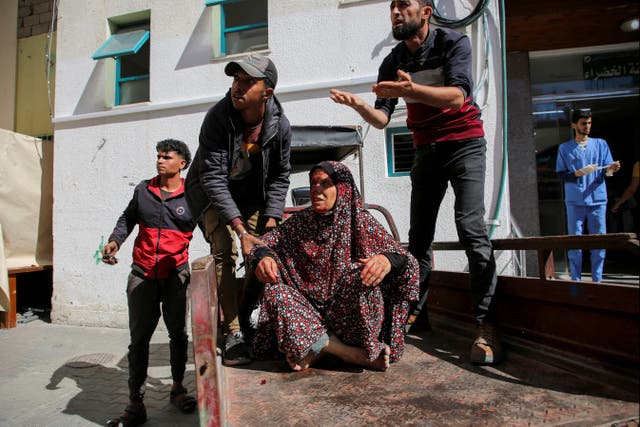 <p>A Palestinian woman wounded in an Israeli strike is rushed into a hospital  in Rafah</p>
