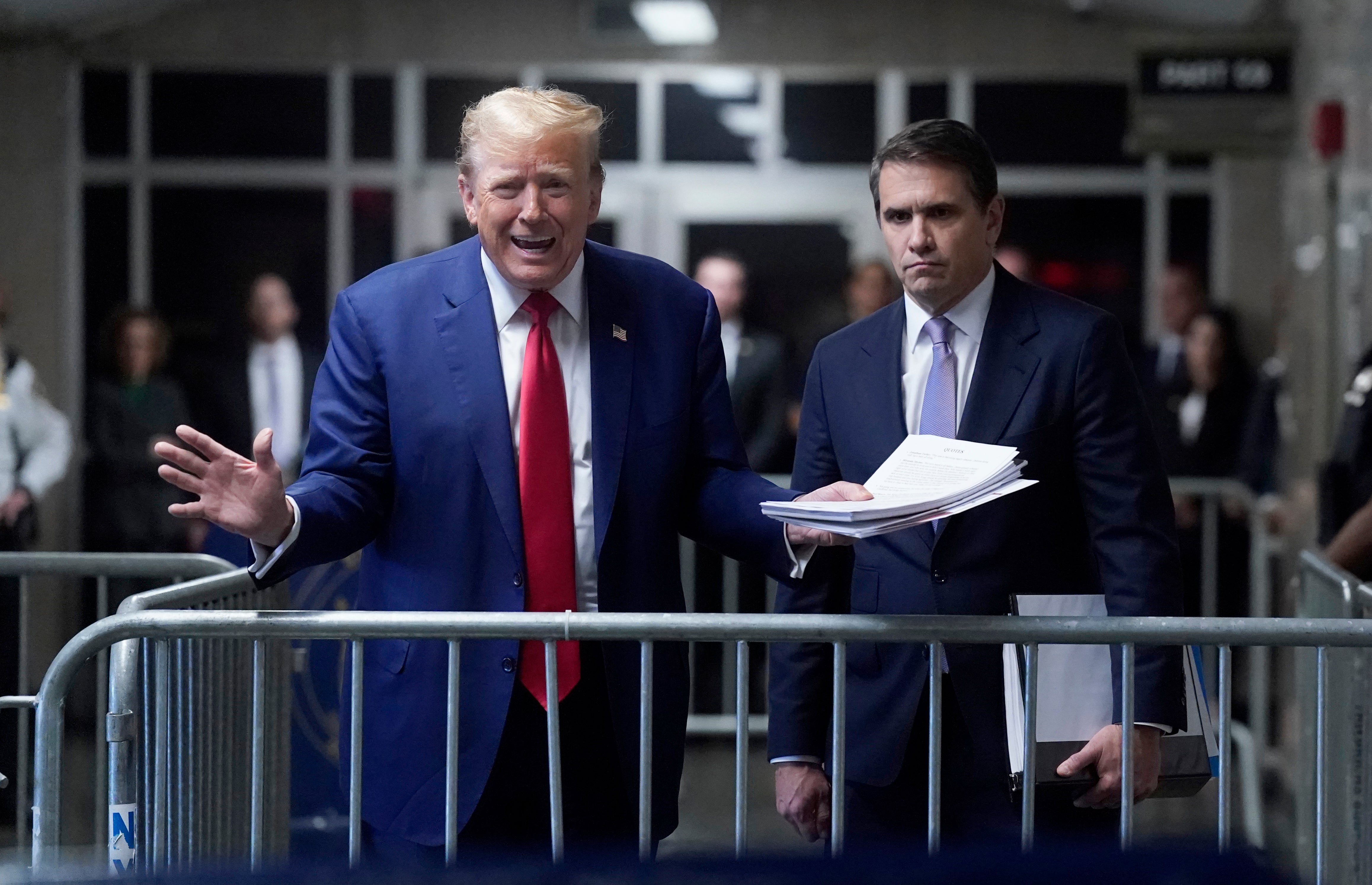 Donald Trump speaks to reporters next to his attorney Todd Blanche inside a criminal courthouse in Manhattan on 10 May.