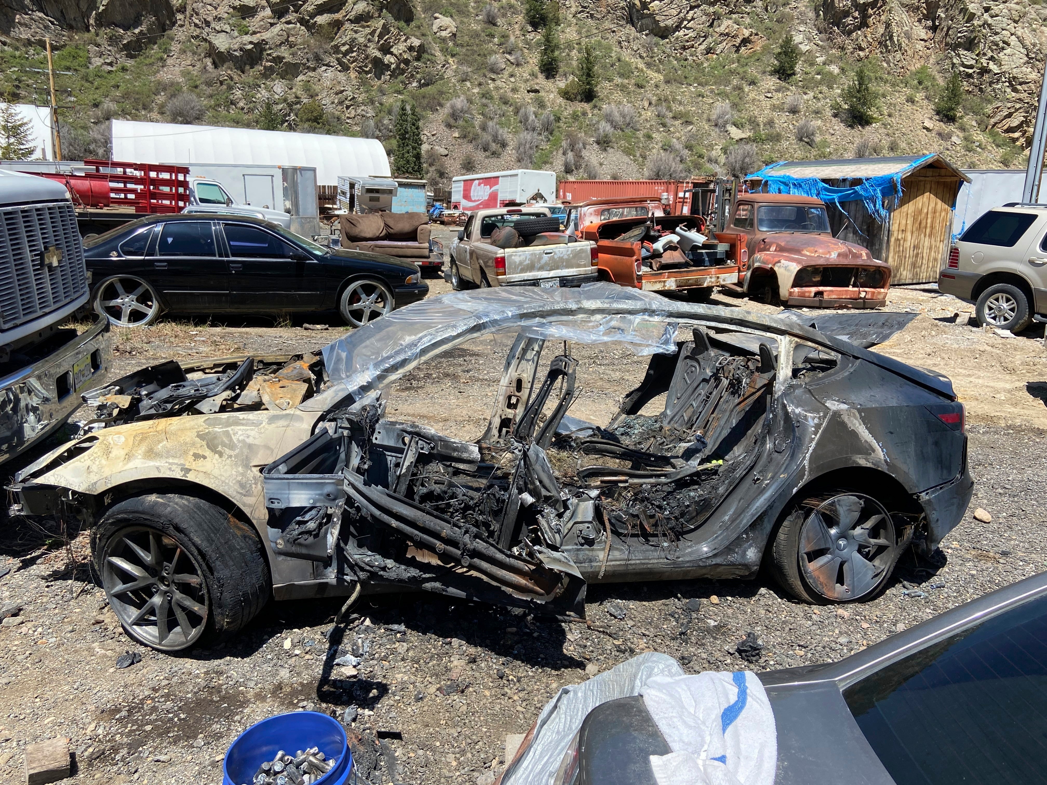 This image provided by Colorado State Patrol shows a Tesla Model 3 that crashed on May 16, 2022 in Clear Creek County, Colo. The widow of a man who died after his Tesla veered off the road and crashed into a tree while he was using its partially automated driving system in Colorado in 2022 is suing the car maker