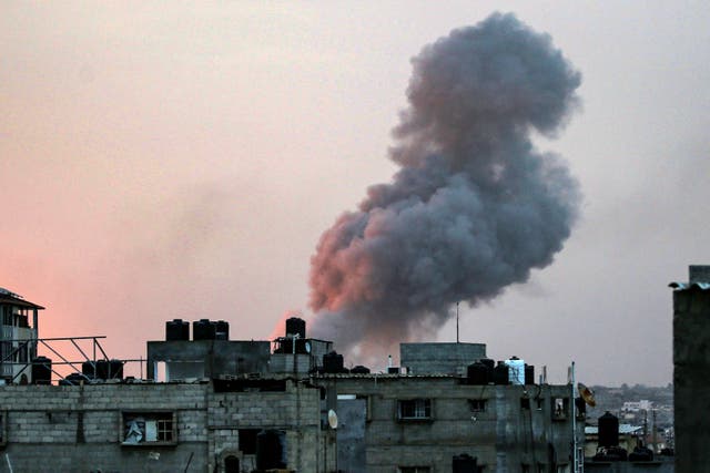 <p>Smoke rises above buildings during an early morning Israeli strike on Rafah in the southern Gaza Strip on 11 May </p>