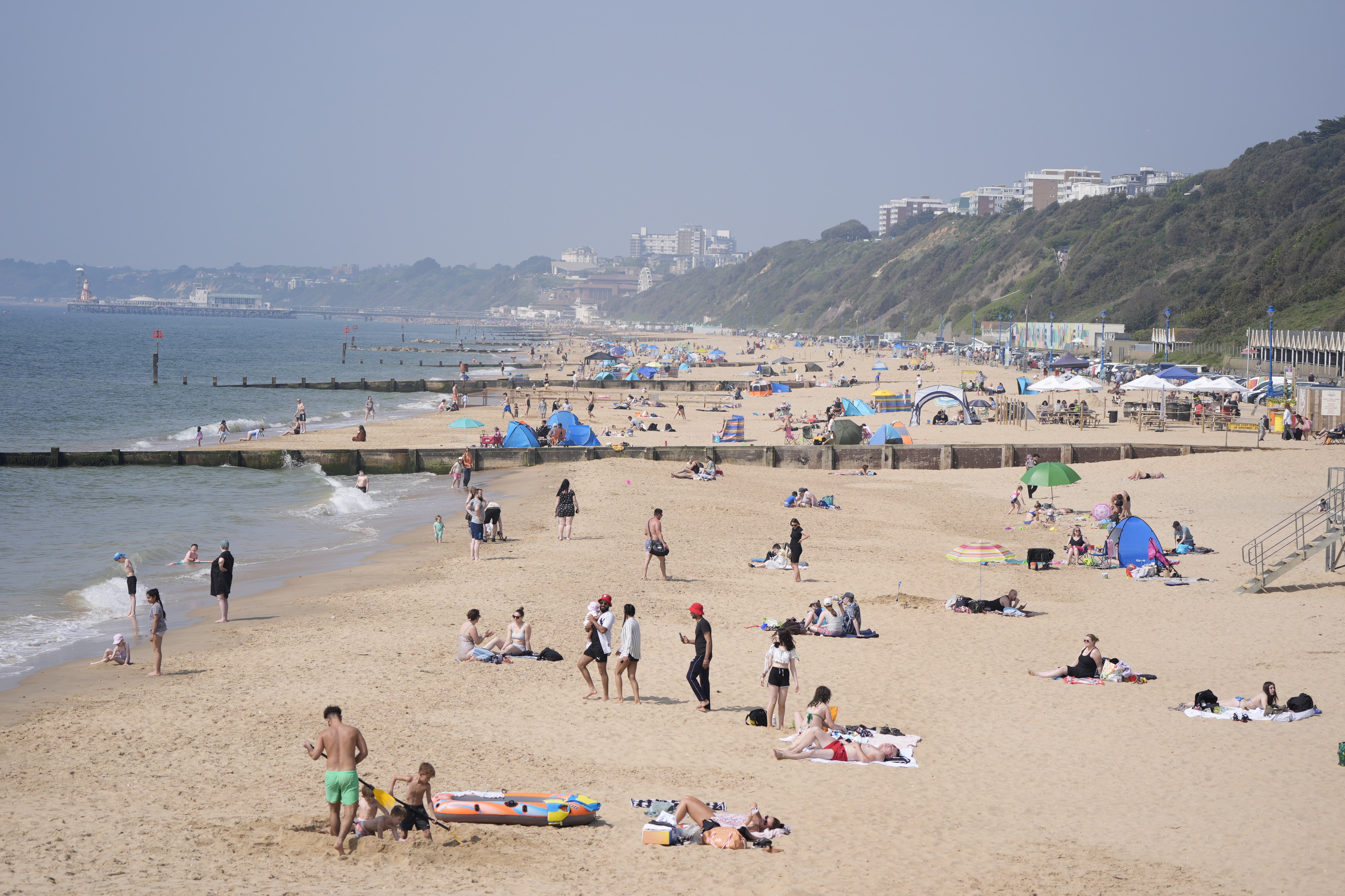 People enjoying the sunny weather on Boscombe Beach (Andrew Matthews/PA)