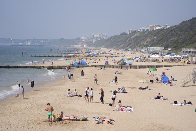 People enjoying the sunny weather on Boscombe Beach (Andrew Matthews/PA)