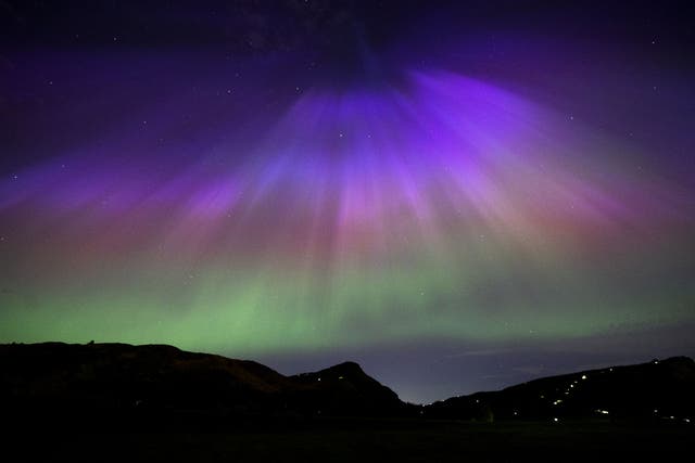 The aurora borealis, also known as the northern lights, above Arthur’s Seat and Salisbury Crags in Holyrood Park, Edinburgh (Jane Barlow/PA)