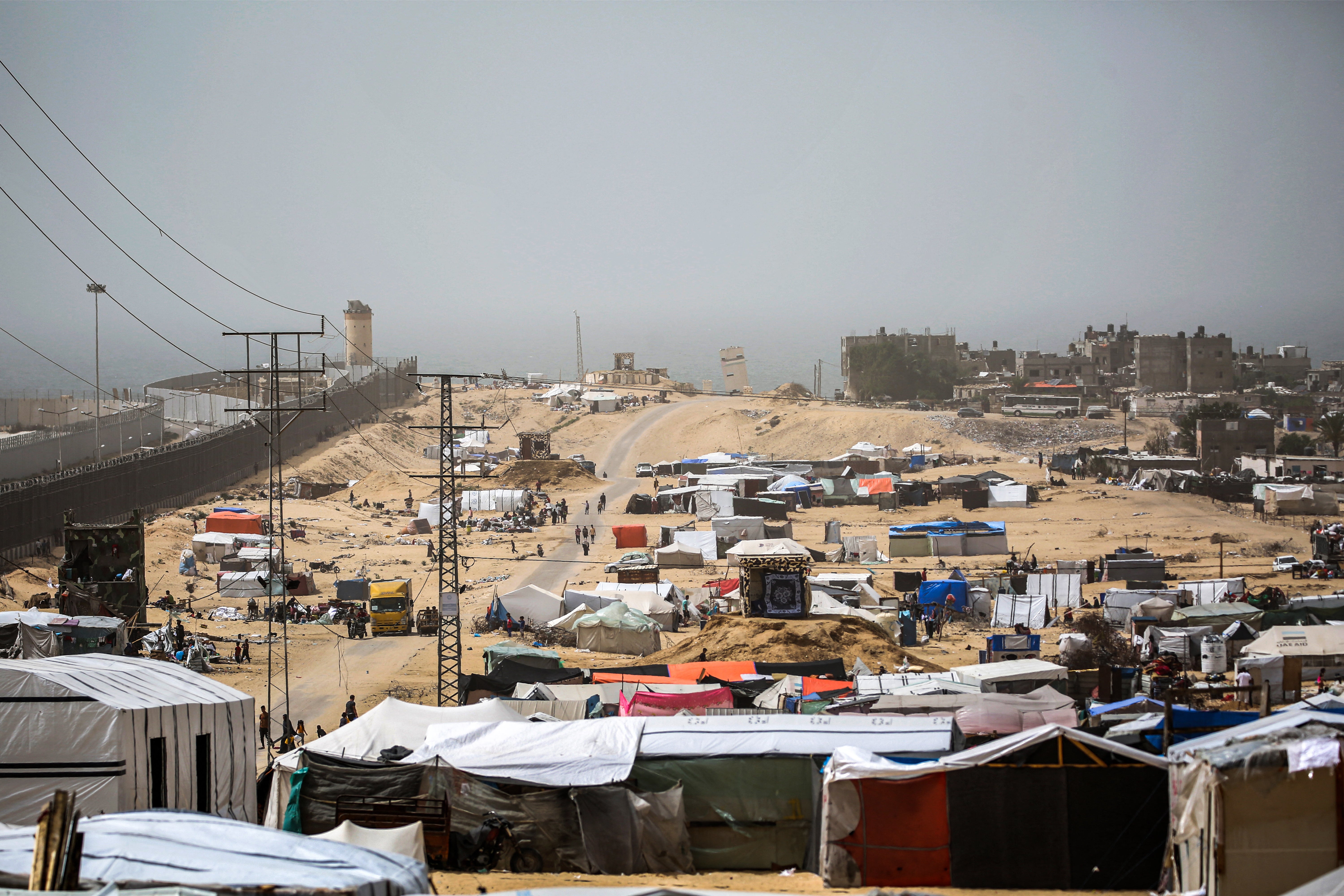 Tent encampments housing displaced Palestinians in Rafah, in the southern Gaza Strip, by the border fence with Egypt
