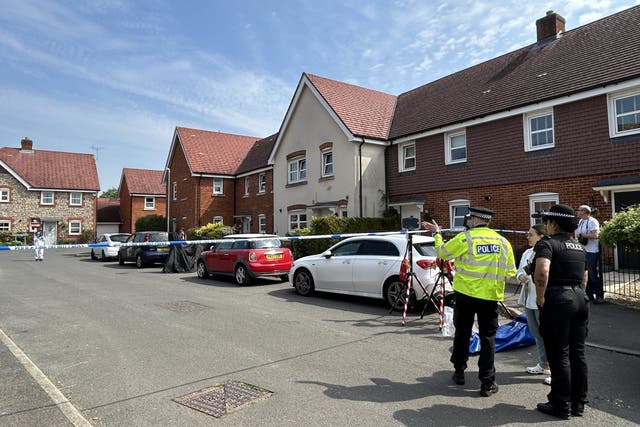 Police and forensic investigators at the scene in High Wycombe, Buckinghamshire after a police officer was shot in the leg with a crossbow after reports of a stabbing (Sam Hall / PA).