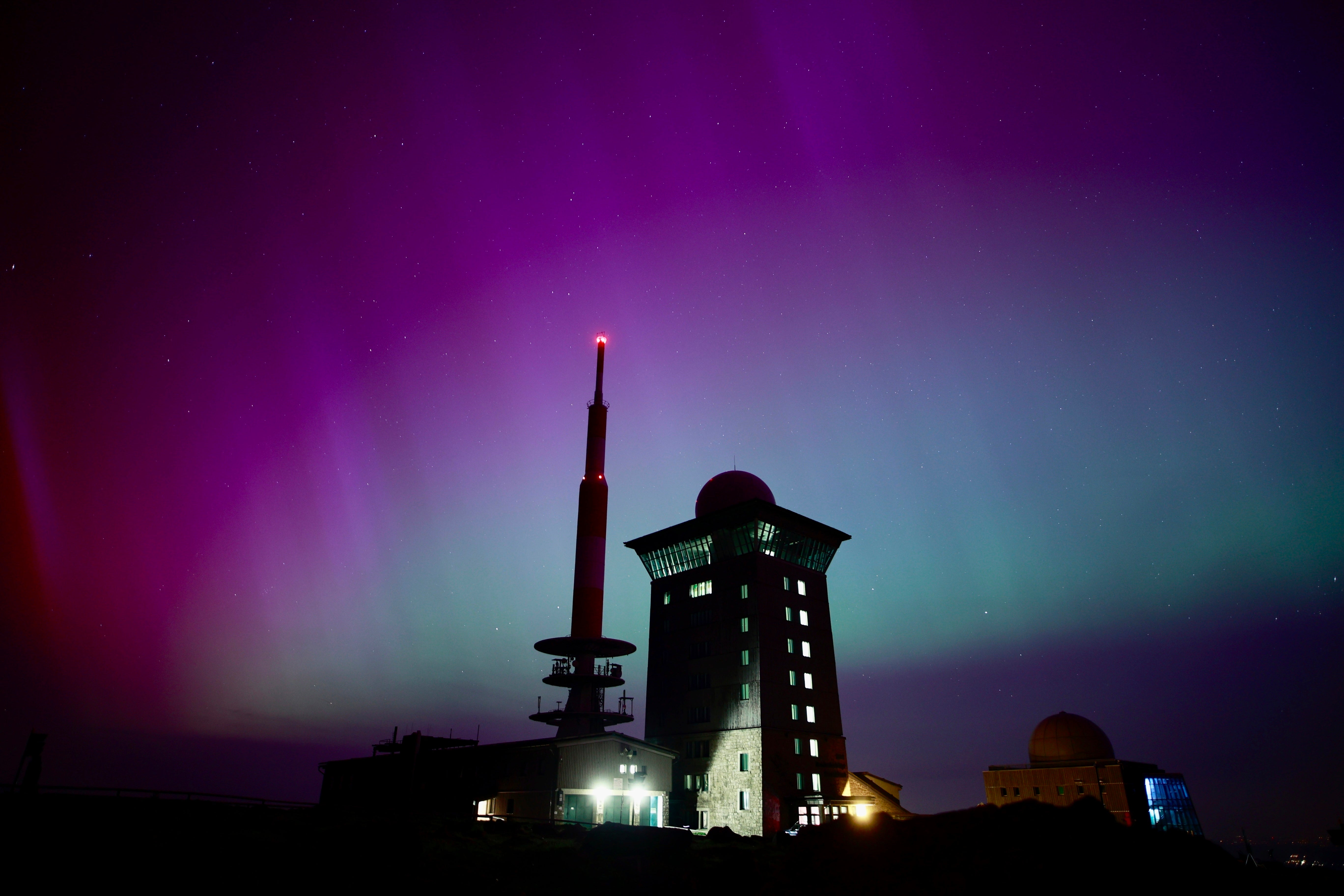 Northern lights appear in the night sky above the Brocken early Saturday, May 11, 2024, in Schierke, northern Germany.