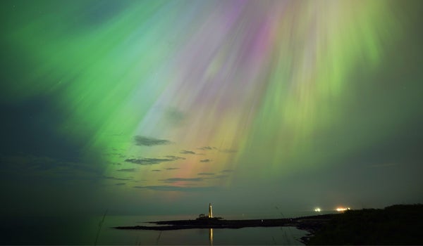 The aurora borealis, also known as the northern lights, glow in the sky over St Mary’s Lighthouse in Whitley Bay on the North East coast on 10 May, 2024