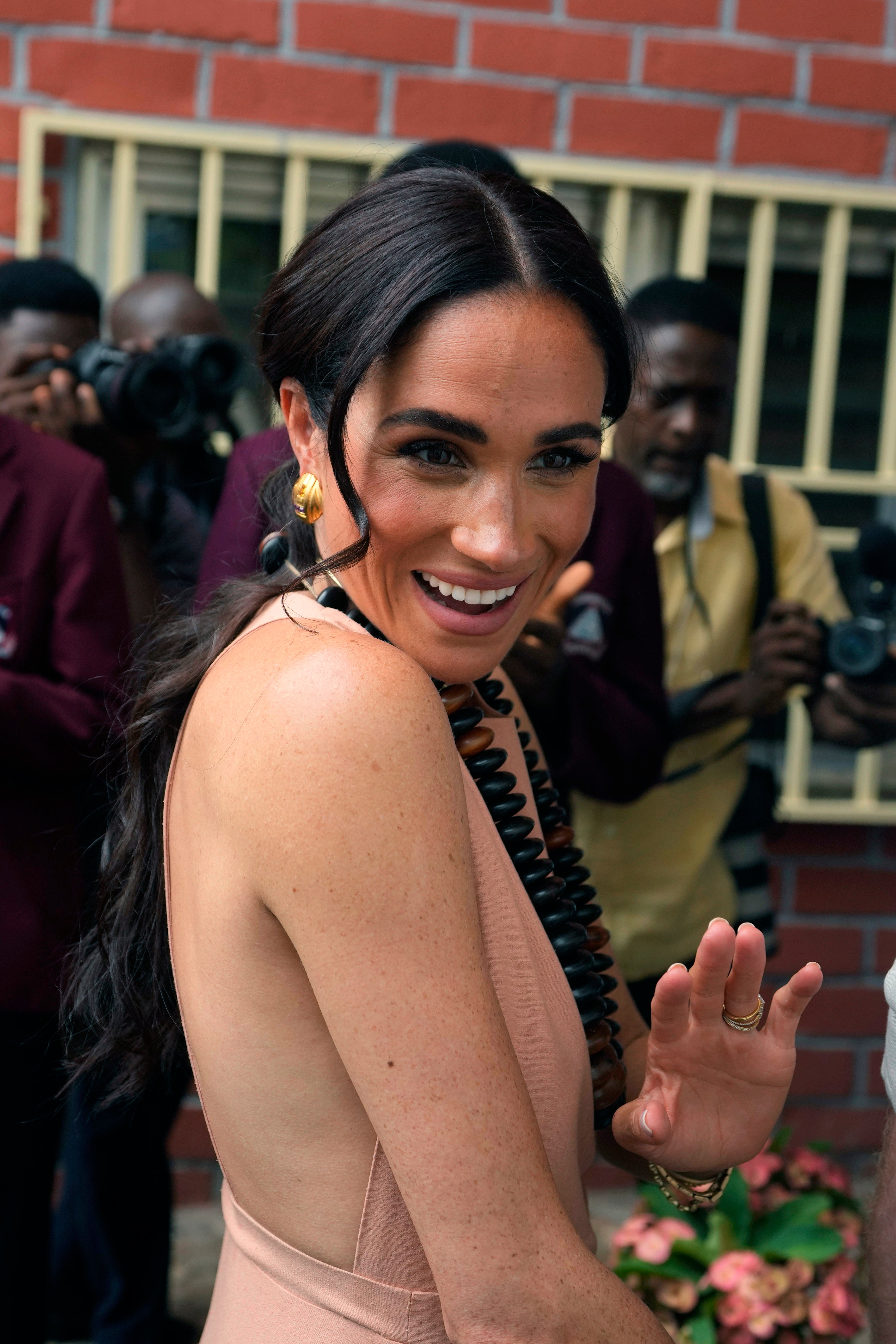 Meghan wore an open-back dress on her and Harry’s unofficial tour of Nigeria