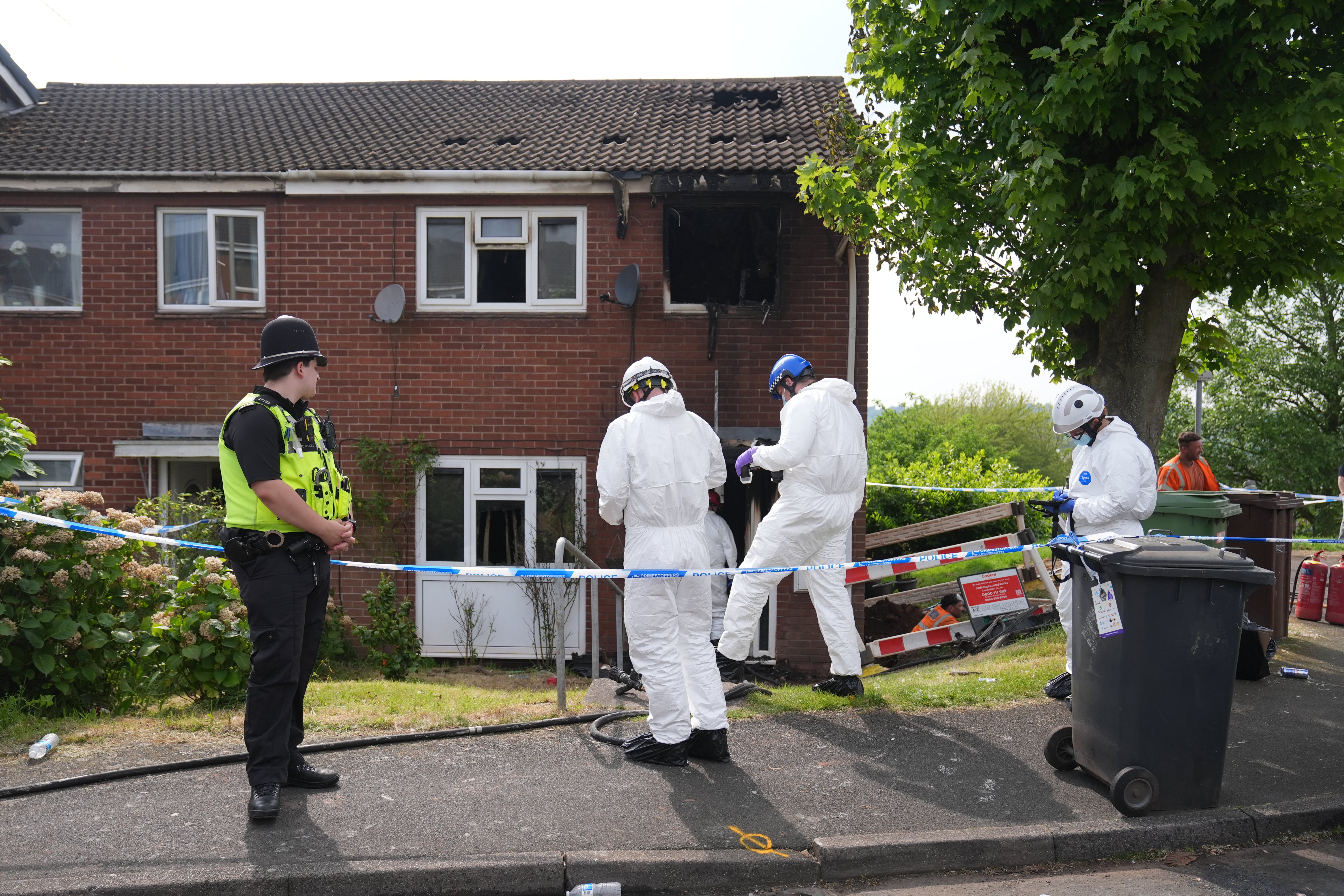 Forensic officers at the scene of a house fire in Wolverhampotn where two people died on Saturday morning