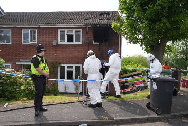 <p>Forensic officers at the scene of a house fire in Wolverhampotn where two people died on Saturday morning</p>