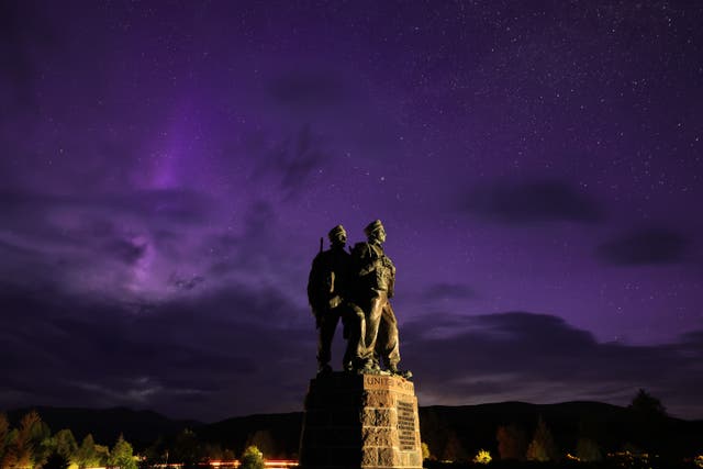<p>A general view of the Commando Memorial as the aurora borealis, commonly known as the Northern Lights, are visible in the early hours on May 12, 2024 in Spean Bridge, Scotland</p>