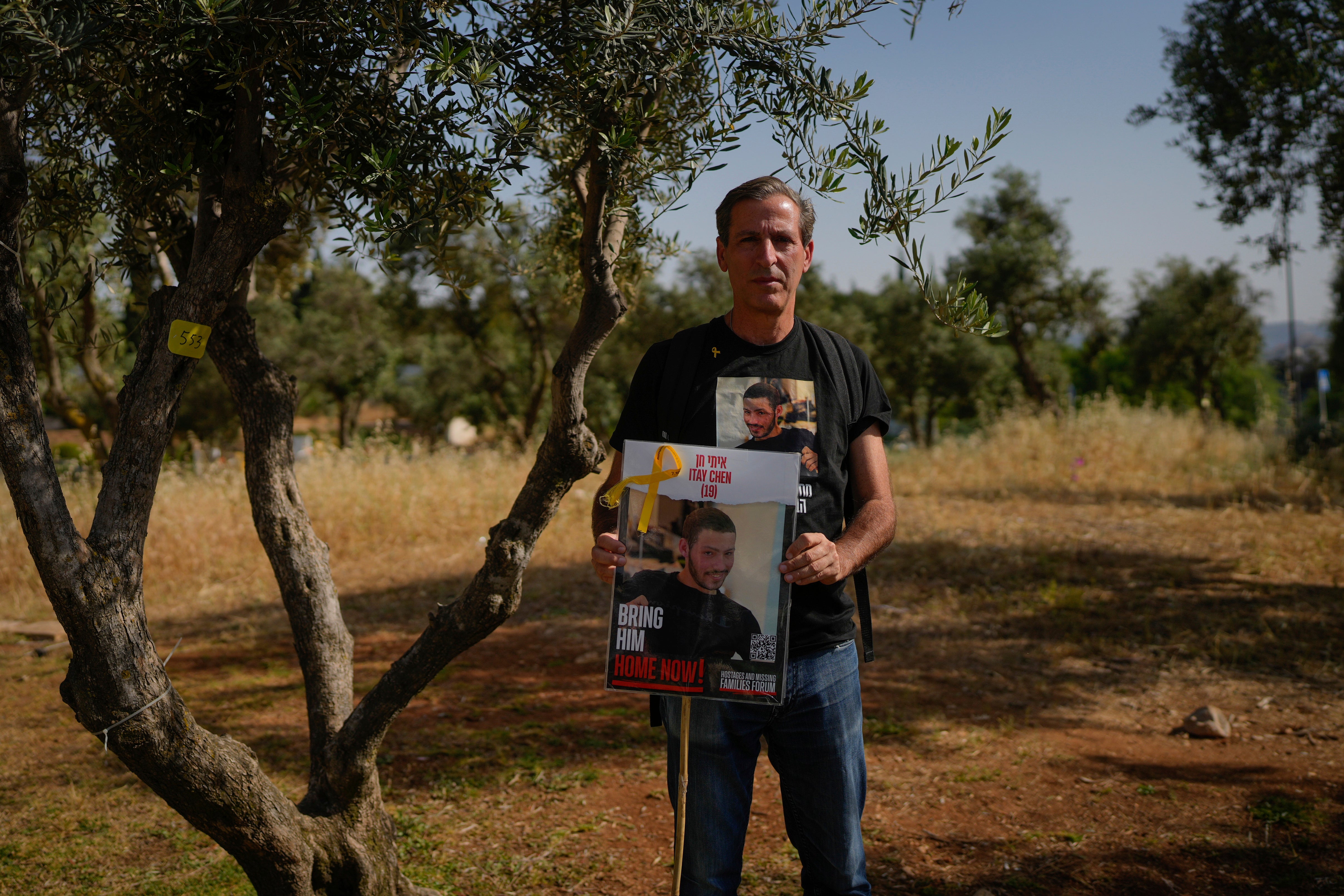 Ruby Chen holds a poster of his son, Itay Chen, during a protest near Israel's parliament in Jerusalem, Thursday, 9 March 2024