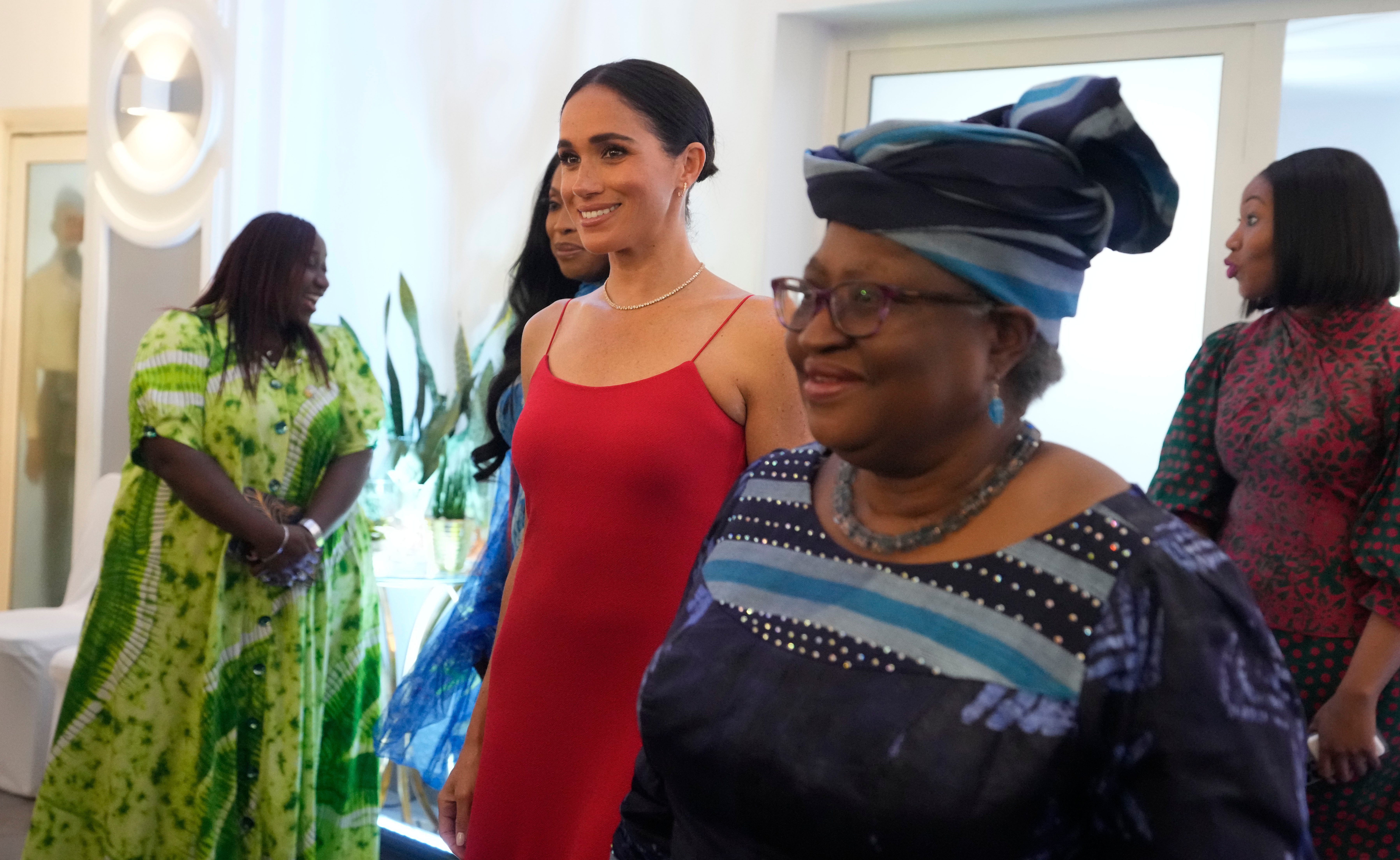 Meghan, the Duchess of Sussex, left, walks alongside Ngozi Okonjo-Iweala, right, Director-General of the World Trade Organization, during an event in Abuja, Nigeria, Saturday