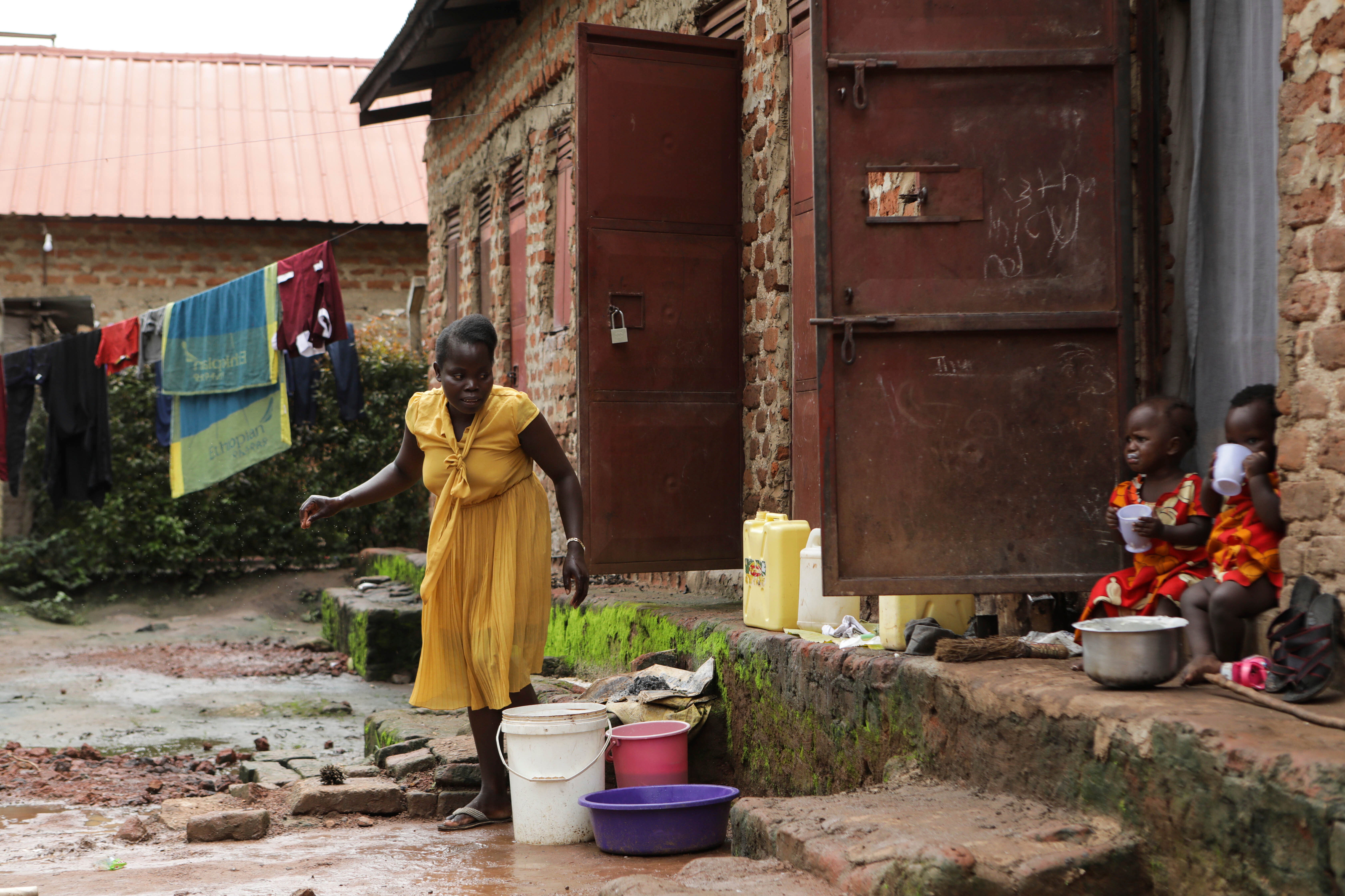 Barbara Nabulo cleans clothes at her home in Busamaga-Mutukula village in Mbale, Uganda, Thursday, April 25