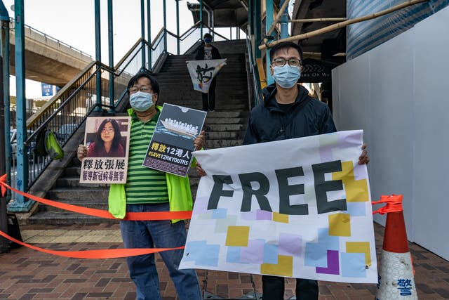 <p>File. Pro-democracy activists in Hong Kong hold placards as they show support for Zhang Zhan who was arrested in mainland China for reporting on Covid-19 pandemic in May 2020</p>