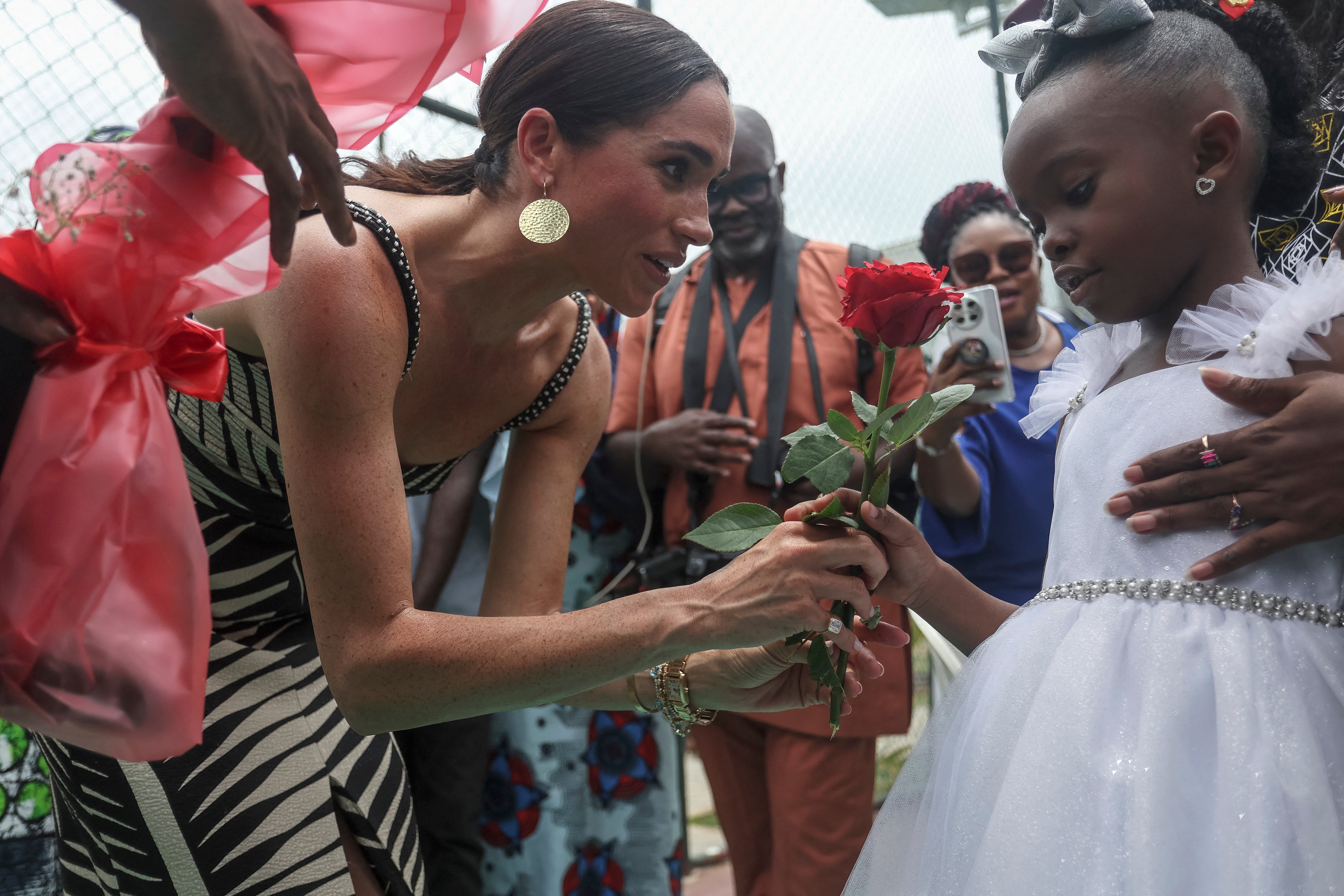 Meghan, Duchess of Sussex, receives flowers upon her arrival in Lagos, the Nigerian capital